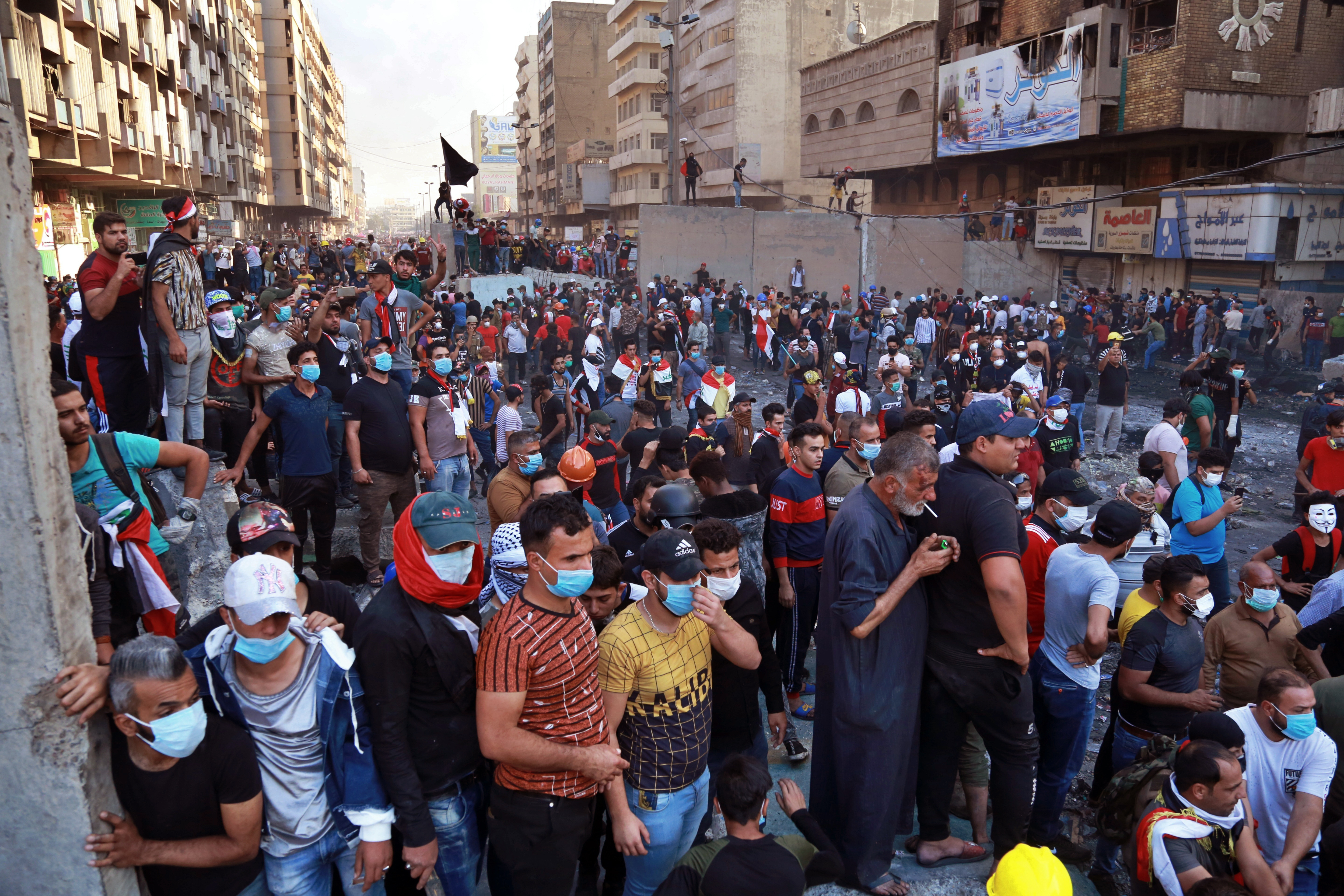 Protesters gather during clashes between Iraqi security forces and anti-Government protesters at Khilani Square in Baghdad, Iraq, on Friday.