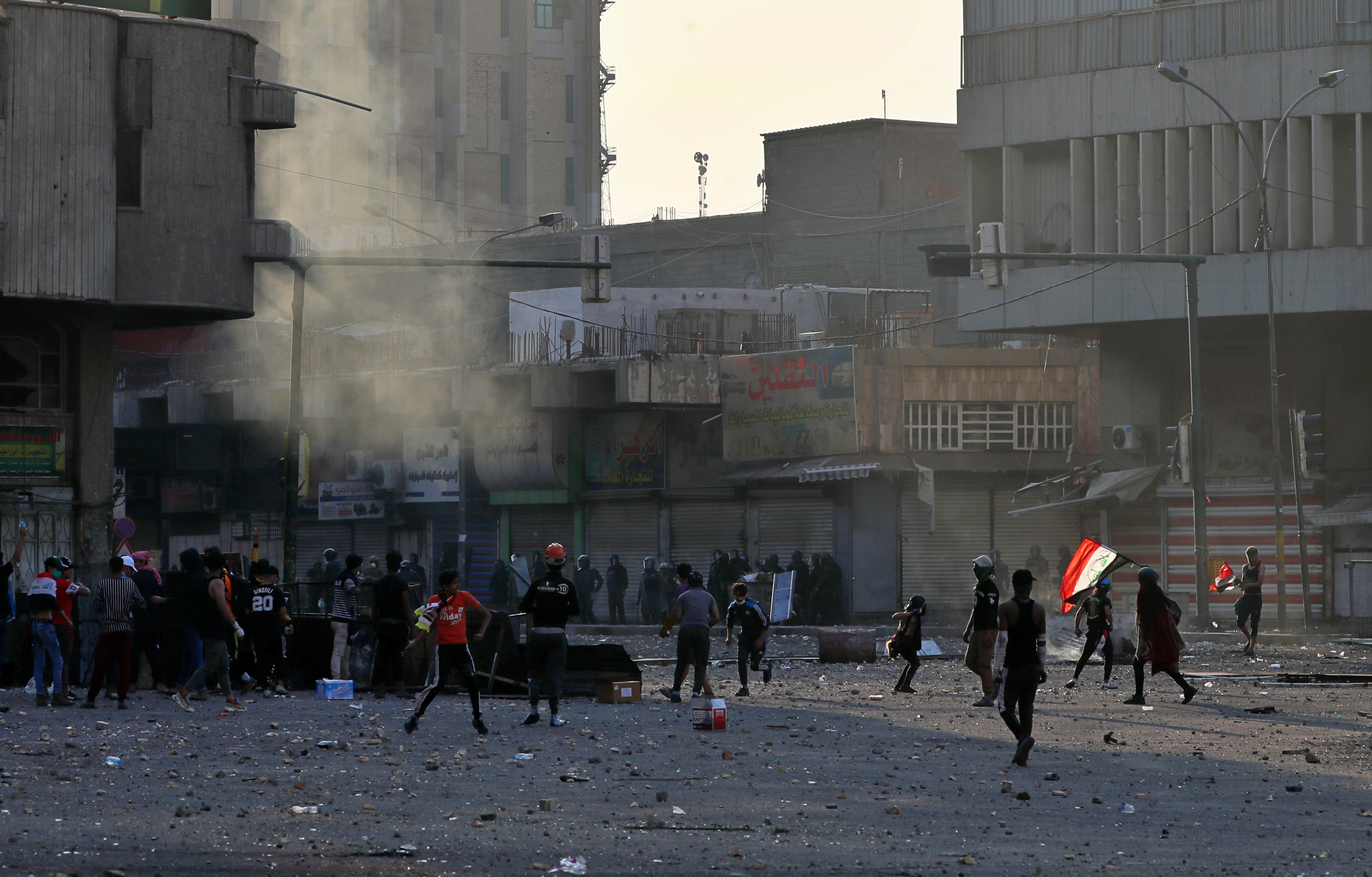 Protesters gather during clashes between Iraqi security forces and anti-Government protesters at Khilani Square in Baghdad, Iraq, on Friday.