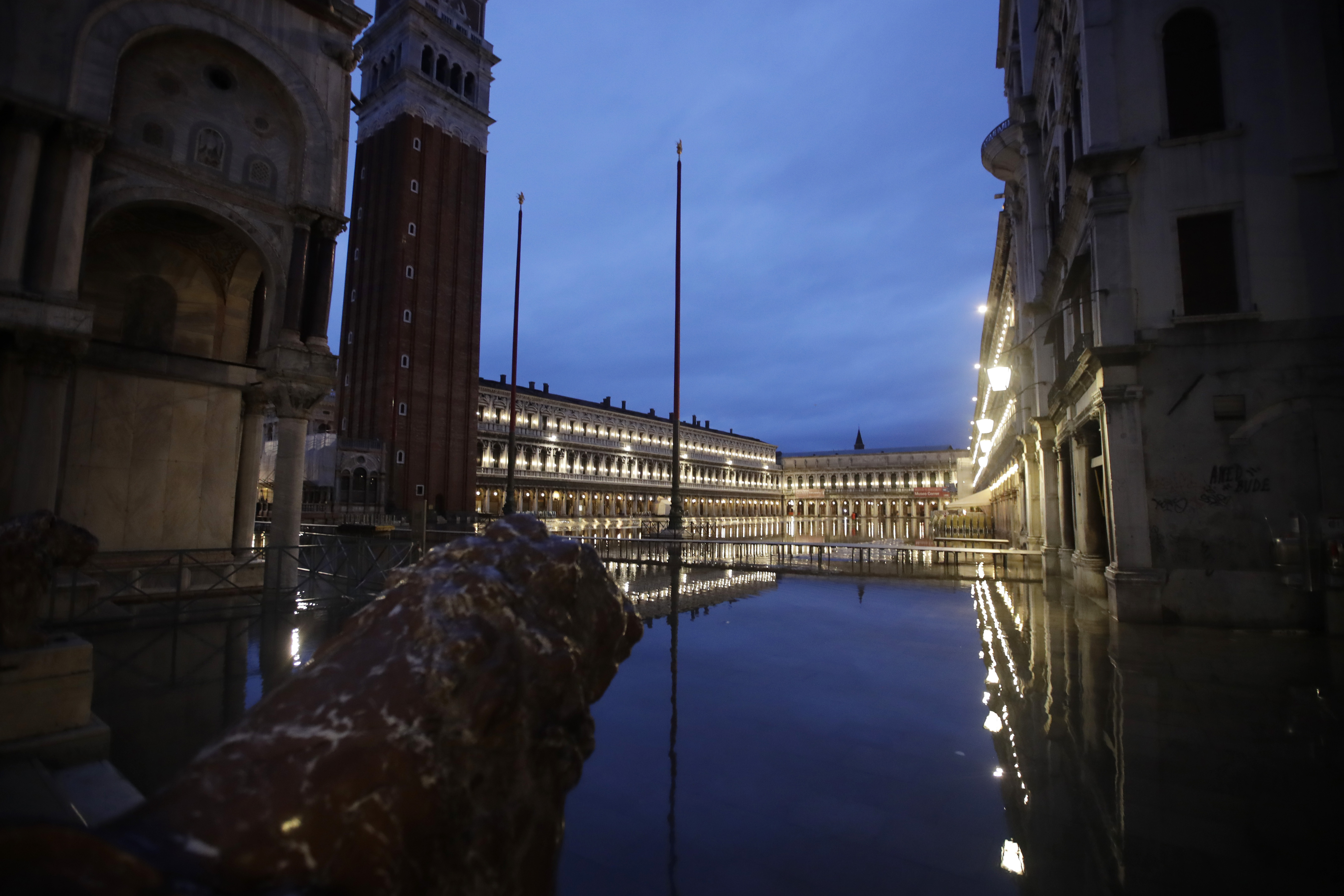 St. Mark square is reflected in flood water at dawn in Venice on Sunday.