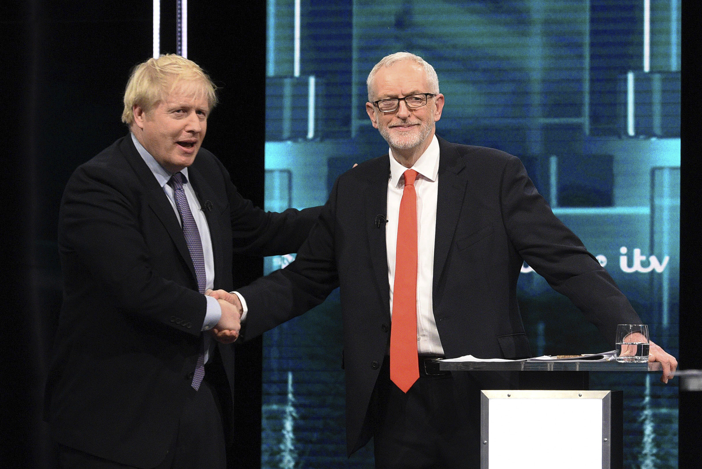 Boris Johnson and Jeremy Corbyn shake hands during their election head-to-head debate live on TV in Manchester on Tuesday.