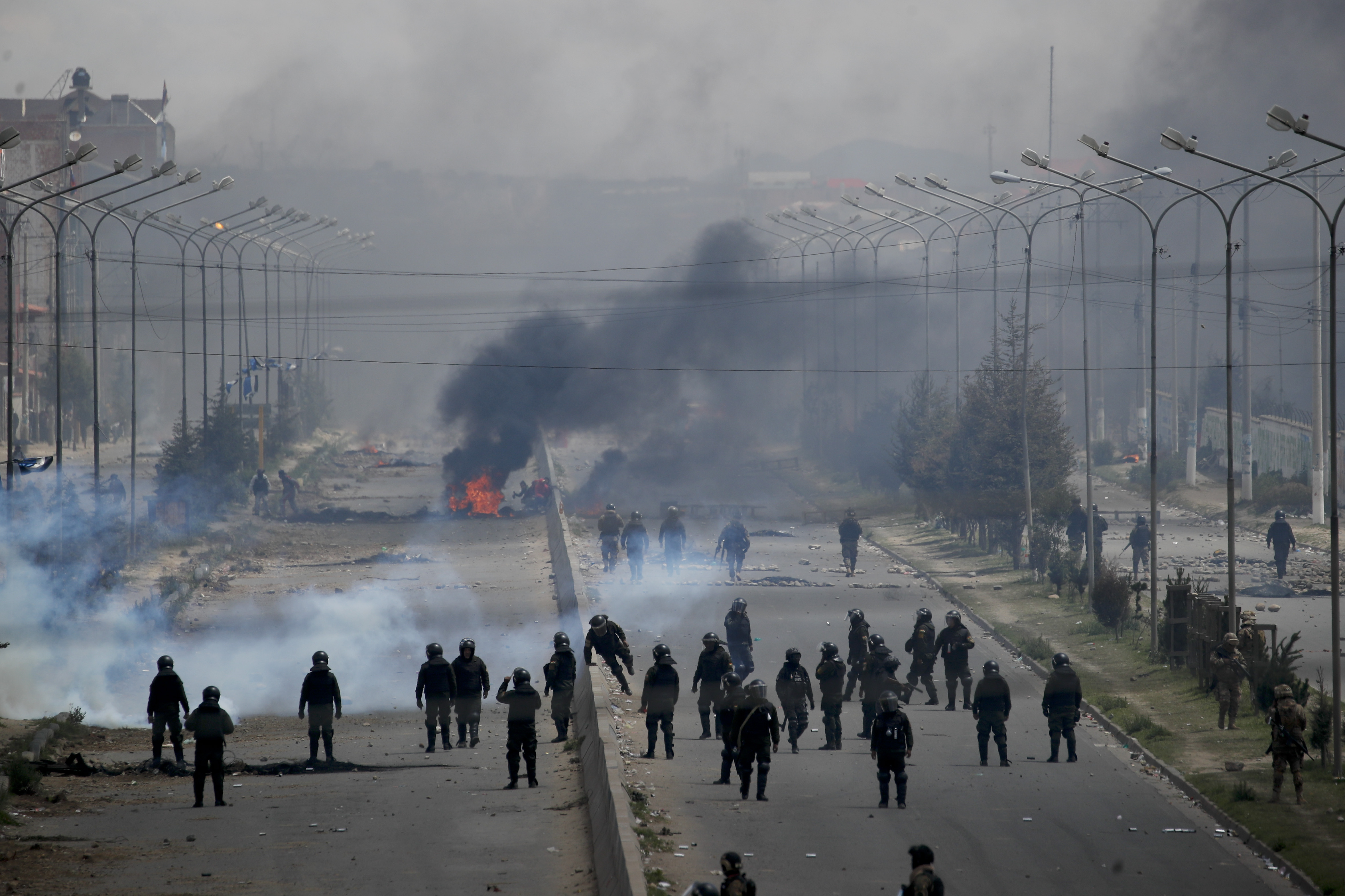 Security forces stand by barricades constructed by supporters of former President Evo Morales along the road leading to the state-own Senkata filling gas plant in El Alto on the outskirts of La Paz, Bolivia on Tuesday.