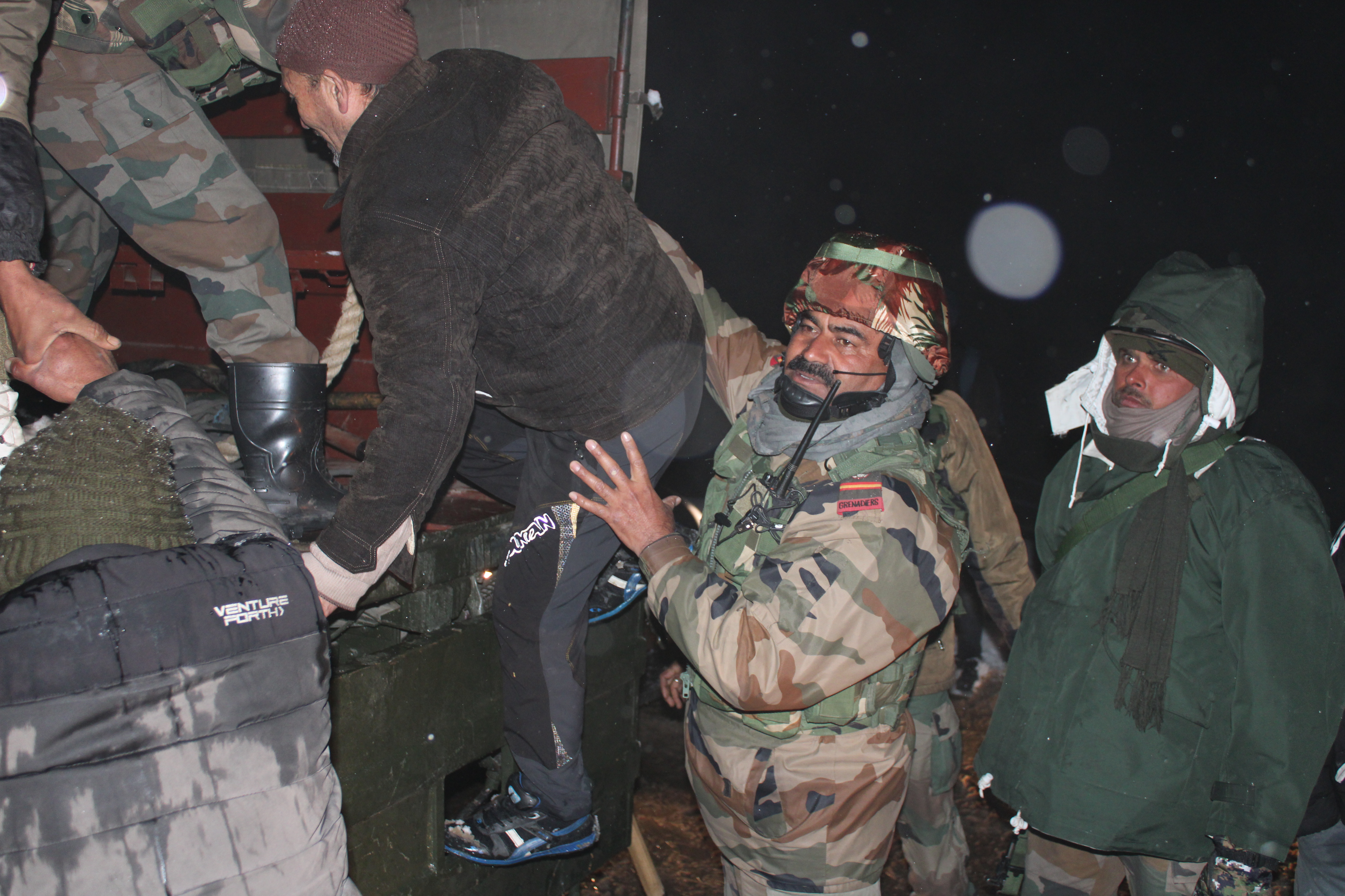 Stranded civilians being ferried in Army vehicle