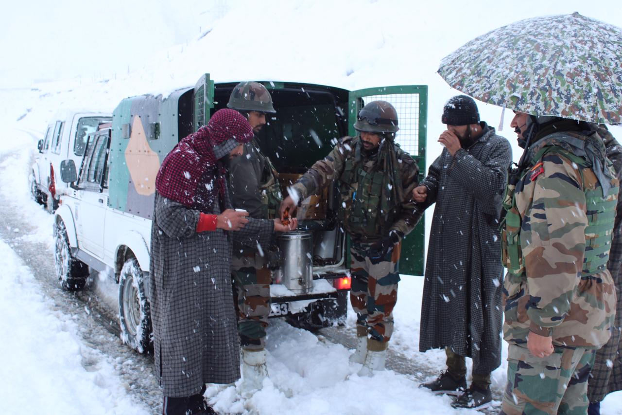 Stranded civilians being served hot tea and food