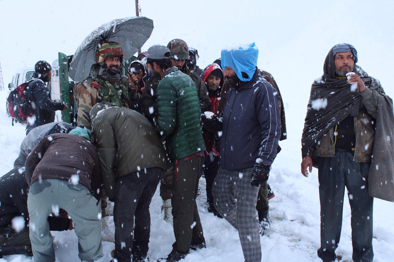 Stranded civilians being served hot tea and food