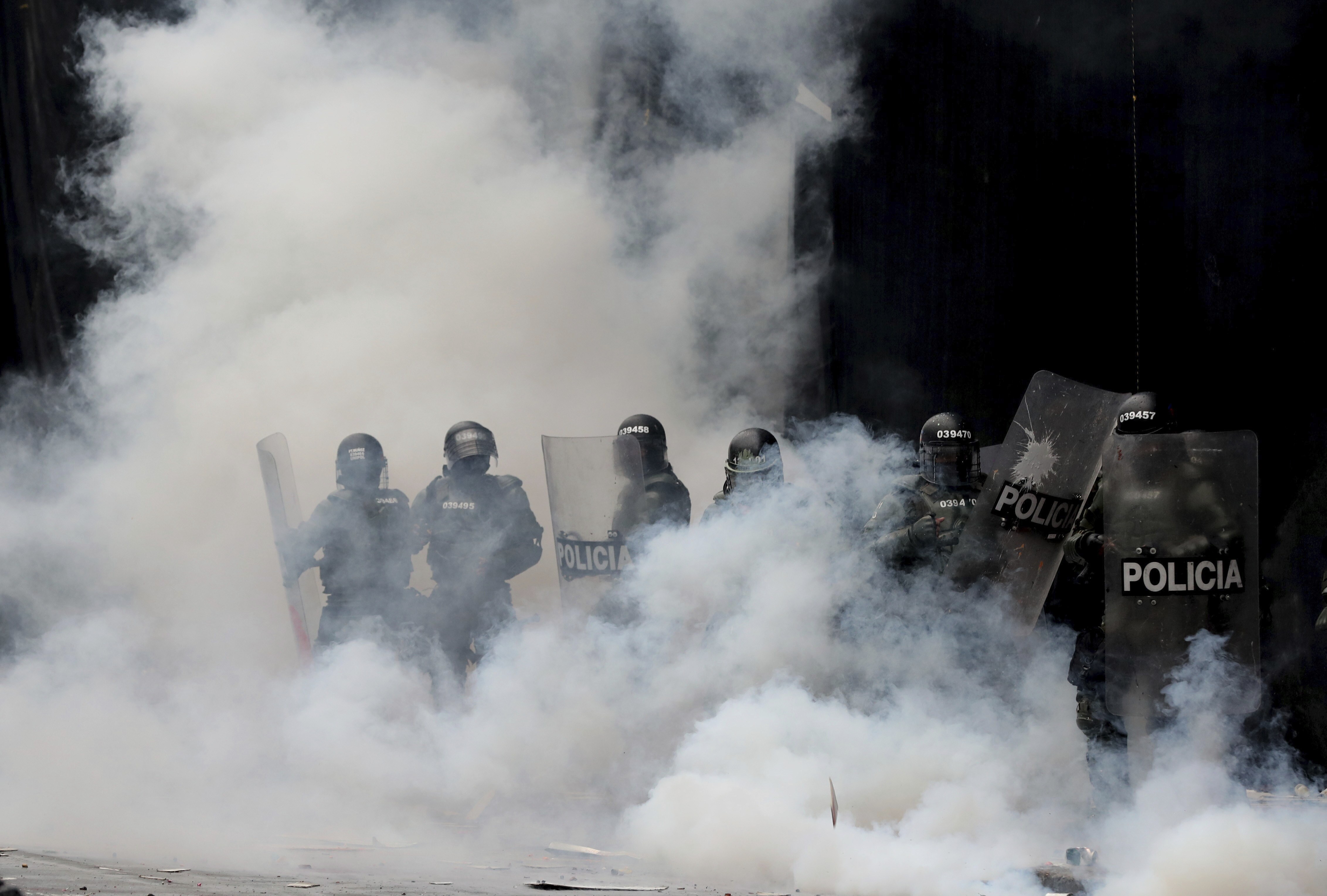 Police are engulfed by a cloud of tear gas after dispersing anti-government protesters at Bolivar square in downtown Bogota, on Thursday.