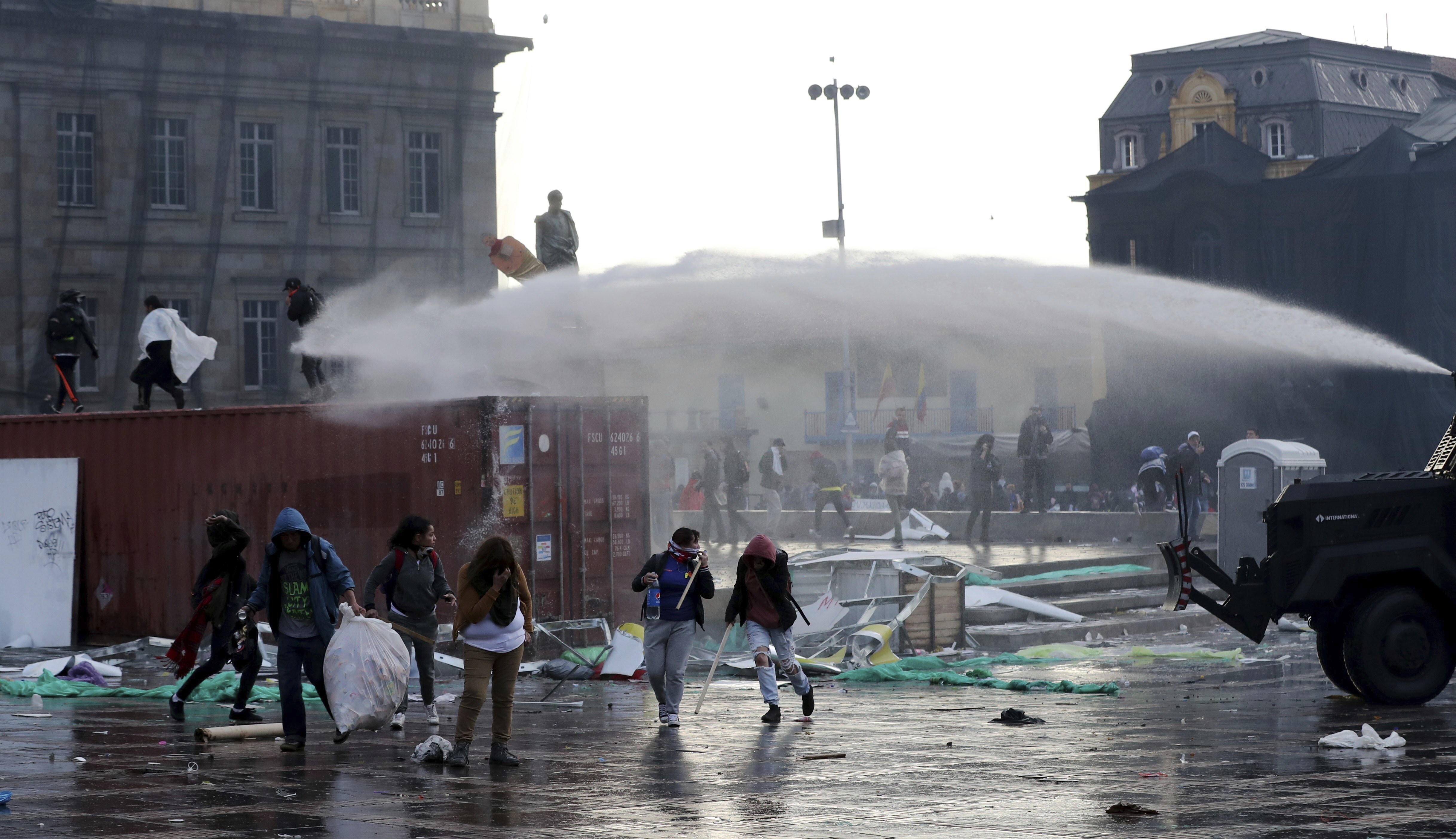 A police water cannon disperses anti-government protesters during a nationwide strike, at Bolivar square in downtown Bogota, on Thursday.