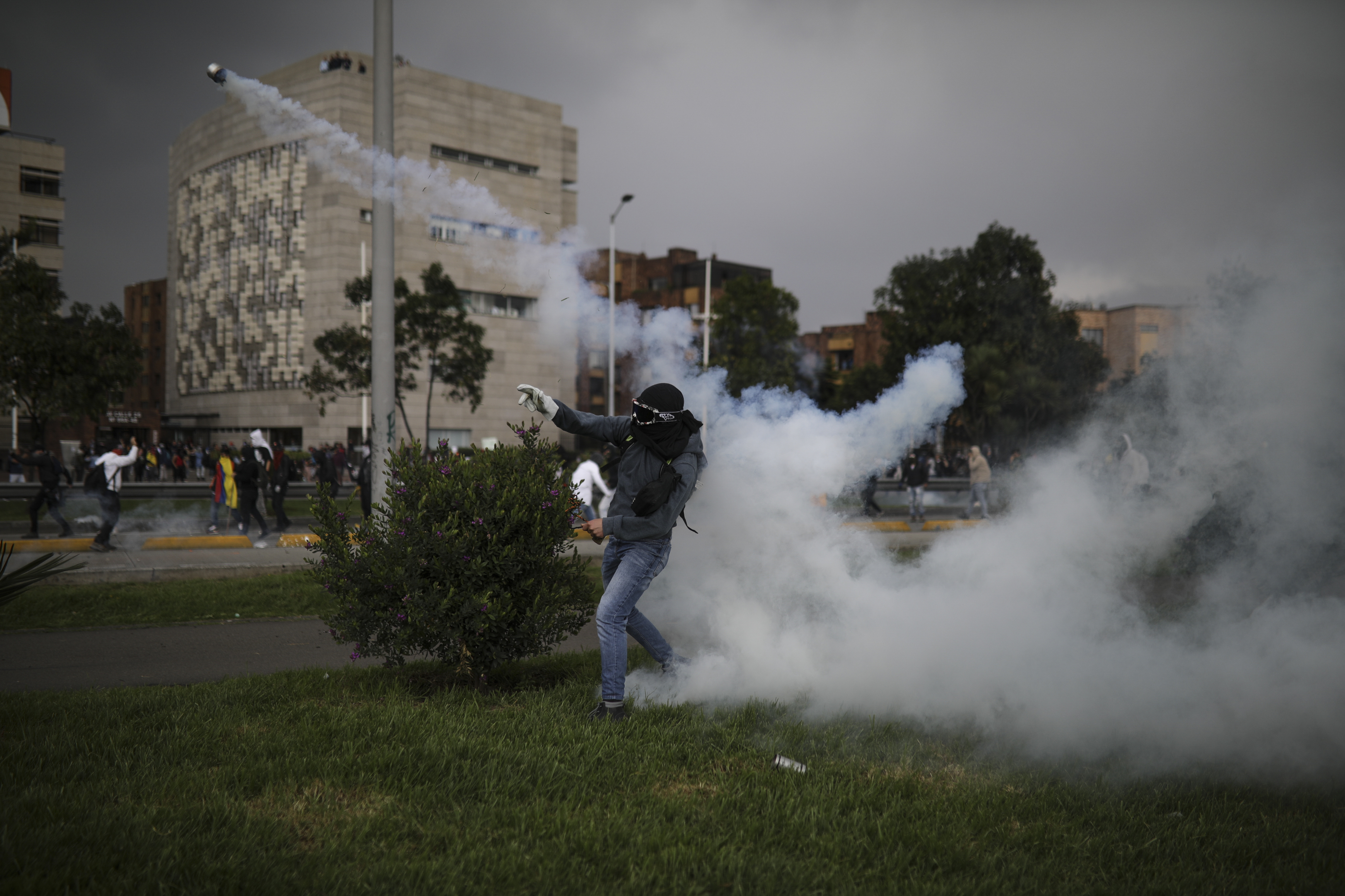 An anti-government protester throws a tear gas canister back at the police during a protest in Bogota, on Thursday.