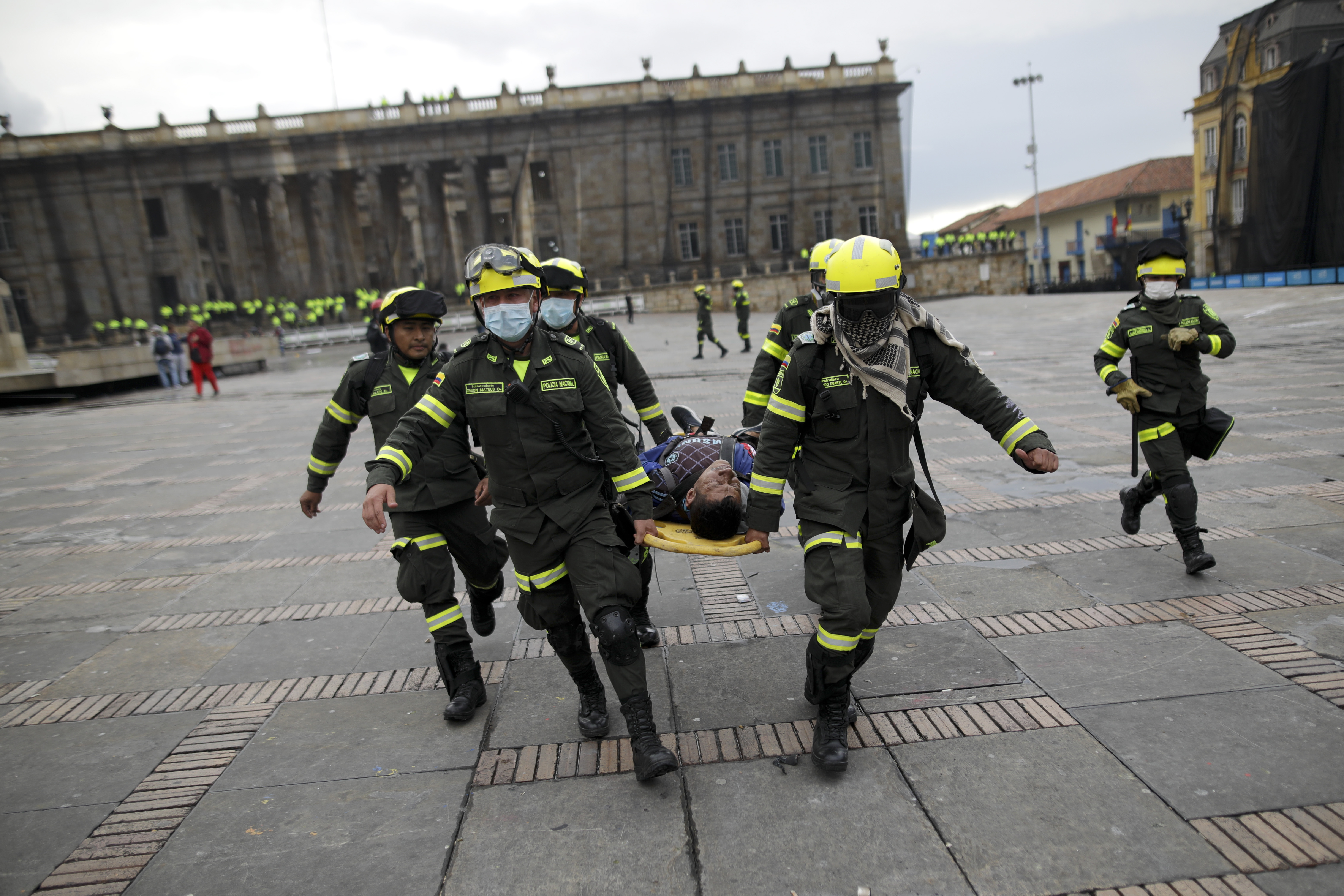 Police carry an anti-government protesters affected by tear gas after clashes at the Bolivar square in downtown Bogota, on Friday.