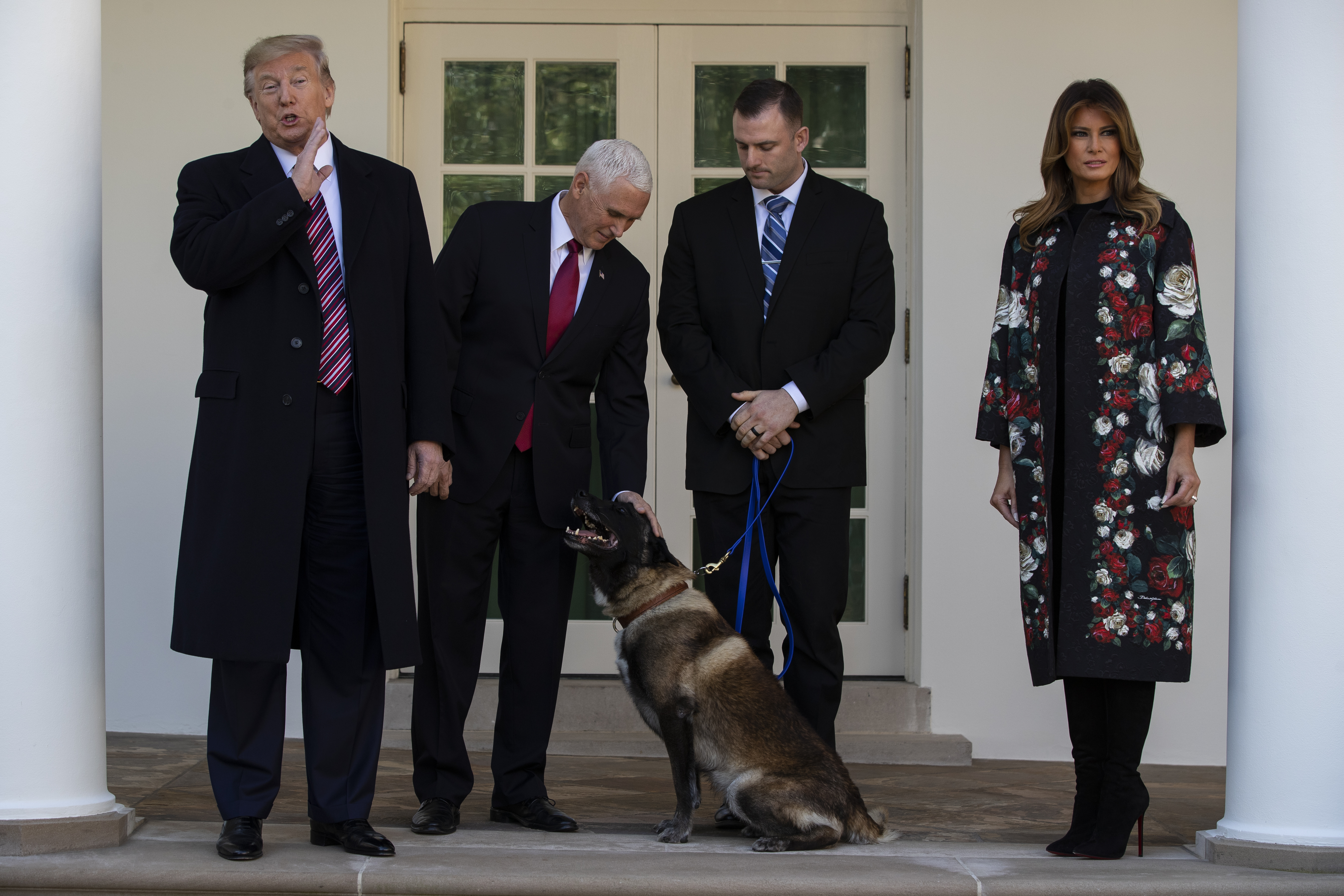 President Donald Trump, Vice President Mike Pence, and first lady Melania Trump stand with Conan, the U.S. Army dog that participated in the raid that killed ISIS leader Abu Bakr al-Baghdadi, in the Rose Garden of the White House, on Monday.