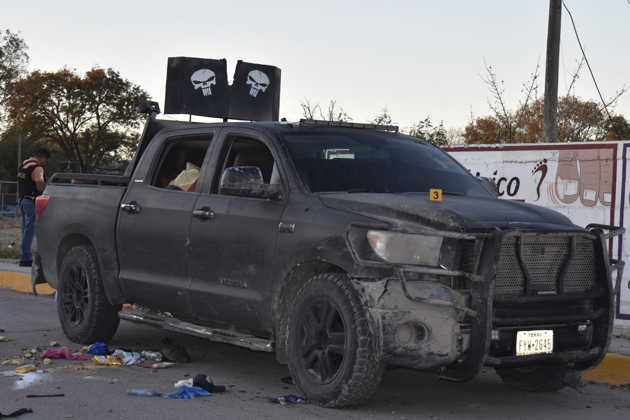 A damaged pick up is on a street of Villa Union, Mexico, after a gun battle between Mexican security forces and suspected cartel gunmen on Saturday.