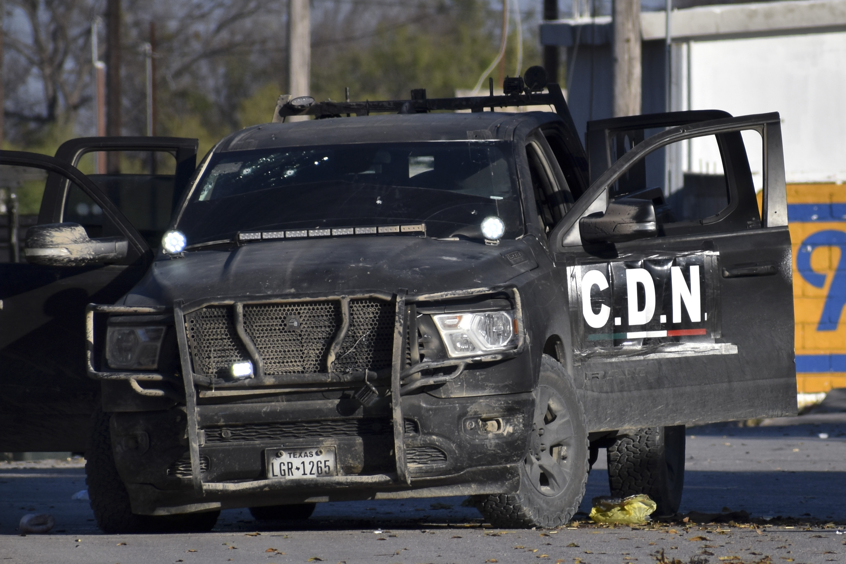 A damaged pick up marked with the initials C.D.N., that in Spanish stand for Cartel of the Northeast, is on the streets after a gun battle between Mexican security forces and suspected cartel gunmen, in Villa Union, Mexico, on Saturday.