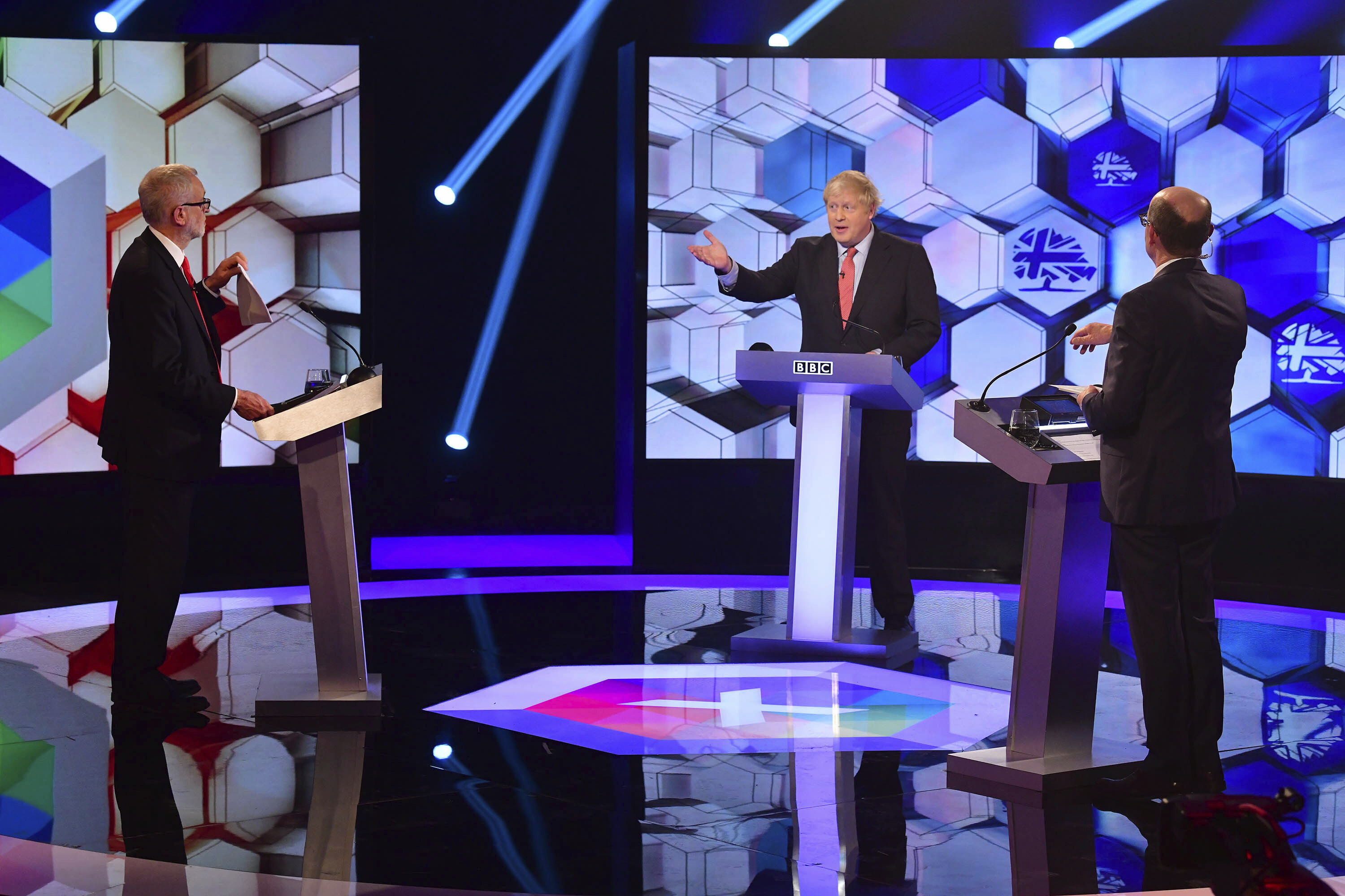 Opposition Labour Party leader Jeremy Corbyn, left, and Britain's Prime Minister Boris Johnson, centre, during a head to head live Election Debate at the BBC TV studios in Maidstone, England, on Friday.