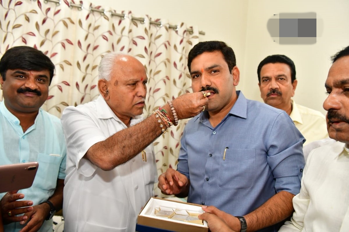 Yediyurappa celebrates BJP's seeming victory with son