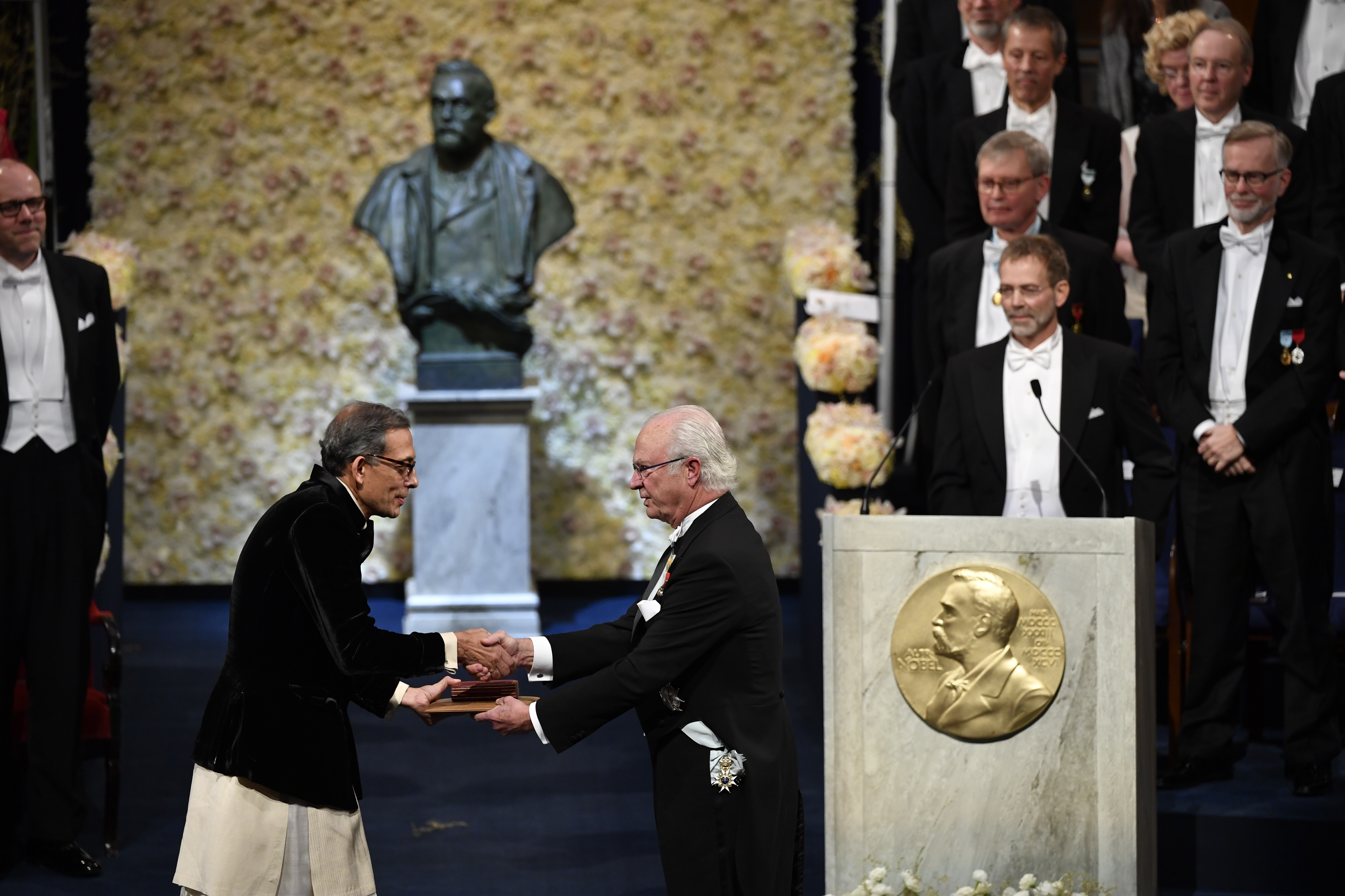 Abhijit Banerjee of India receives the Sveriges Riksbank Prize in Economic Sciences in Memory of Alfred Nobel from King Carl Gustaf of Sweden during the Nobel Prize award ceremony at the Stockholm Concert Hall in Stockholm, on Tuesday.