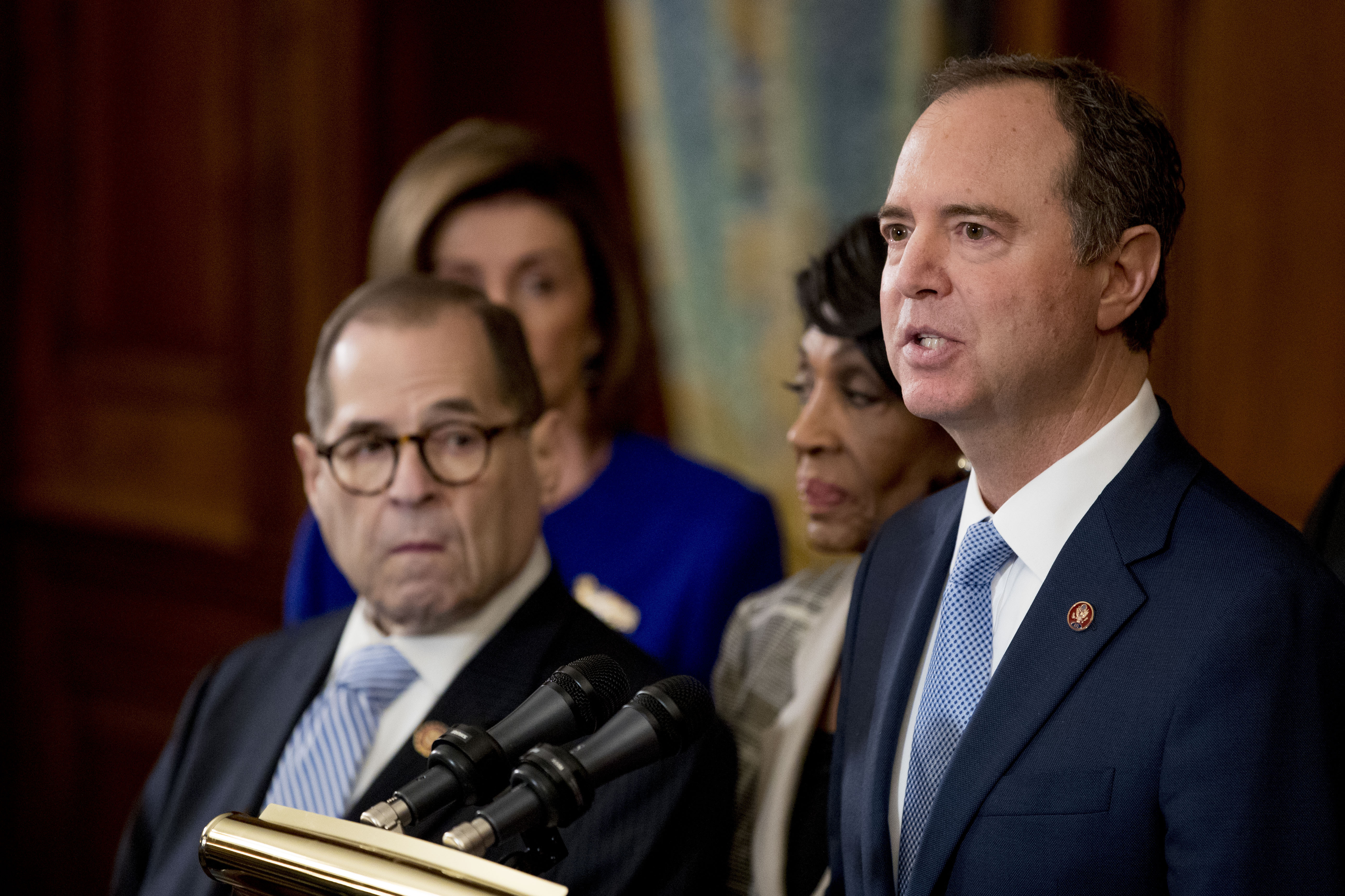 Rep. Adam Schiff, D-Calif., Chairman of the House Intelligence Committee, right, speaks with from left Chairman of the House Judiciary Committee Jerrold Nadler, D-N.Y., House Speaker Nancy Pelosi and Chairwoman of the House Financial Services Committee Maxine Waters, D-Calif., second from right, during a news conference to unveil articles of impeachment against President Donald Trump, abuse of power and obstruction of Congress, on Tuesday.
