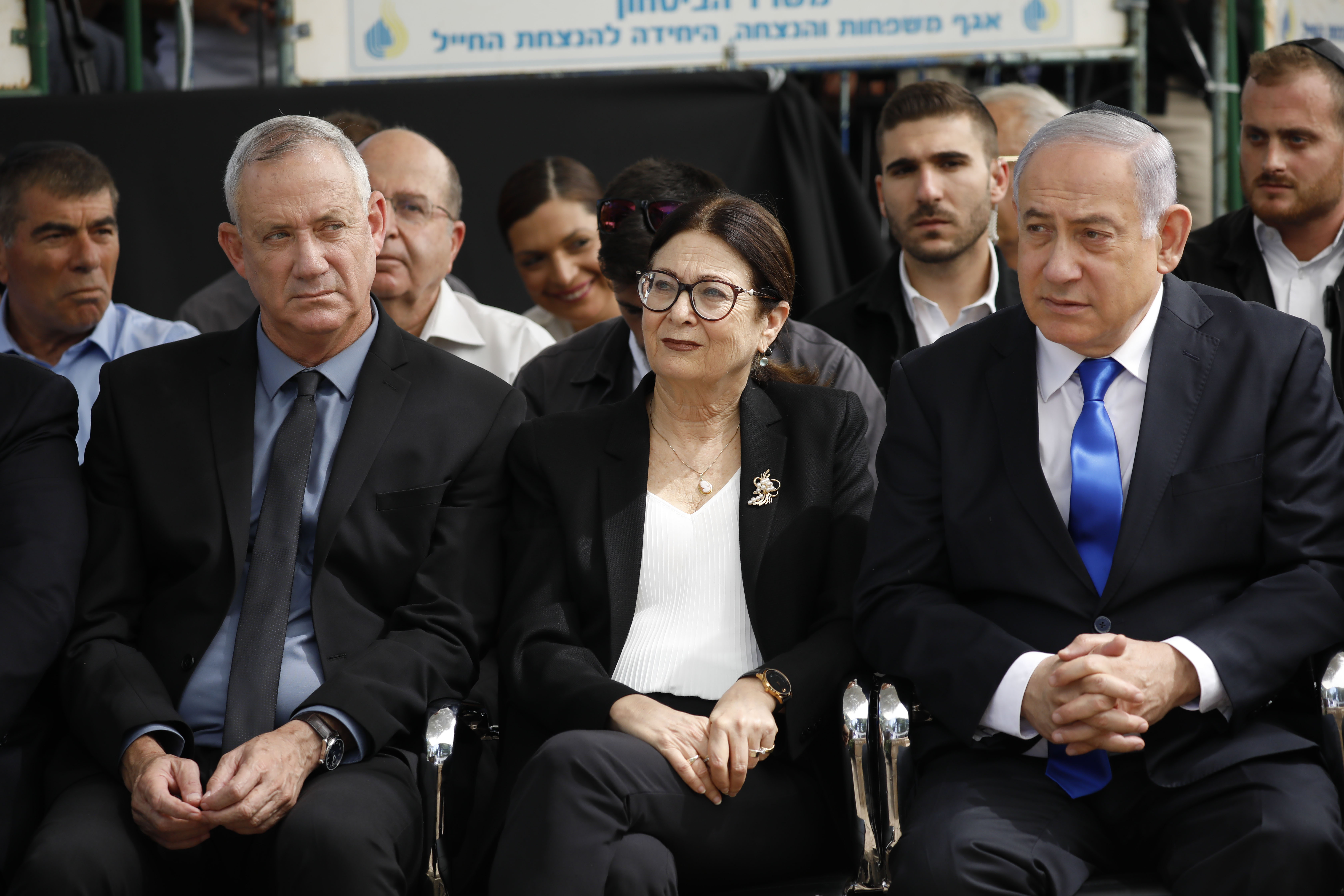 Blue and White party leader Benny Gantz, left, Esther Hayut, the Chief Justice of the Supreme Court of Israel, center, and Israeli Prime Minister Benjamin Netanyahu attend a memorial service for former President Shimon Peres in Jerusalem.