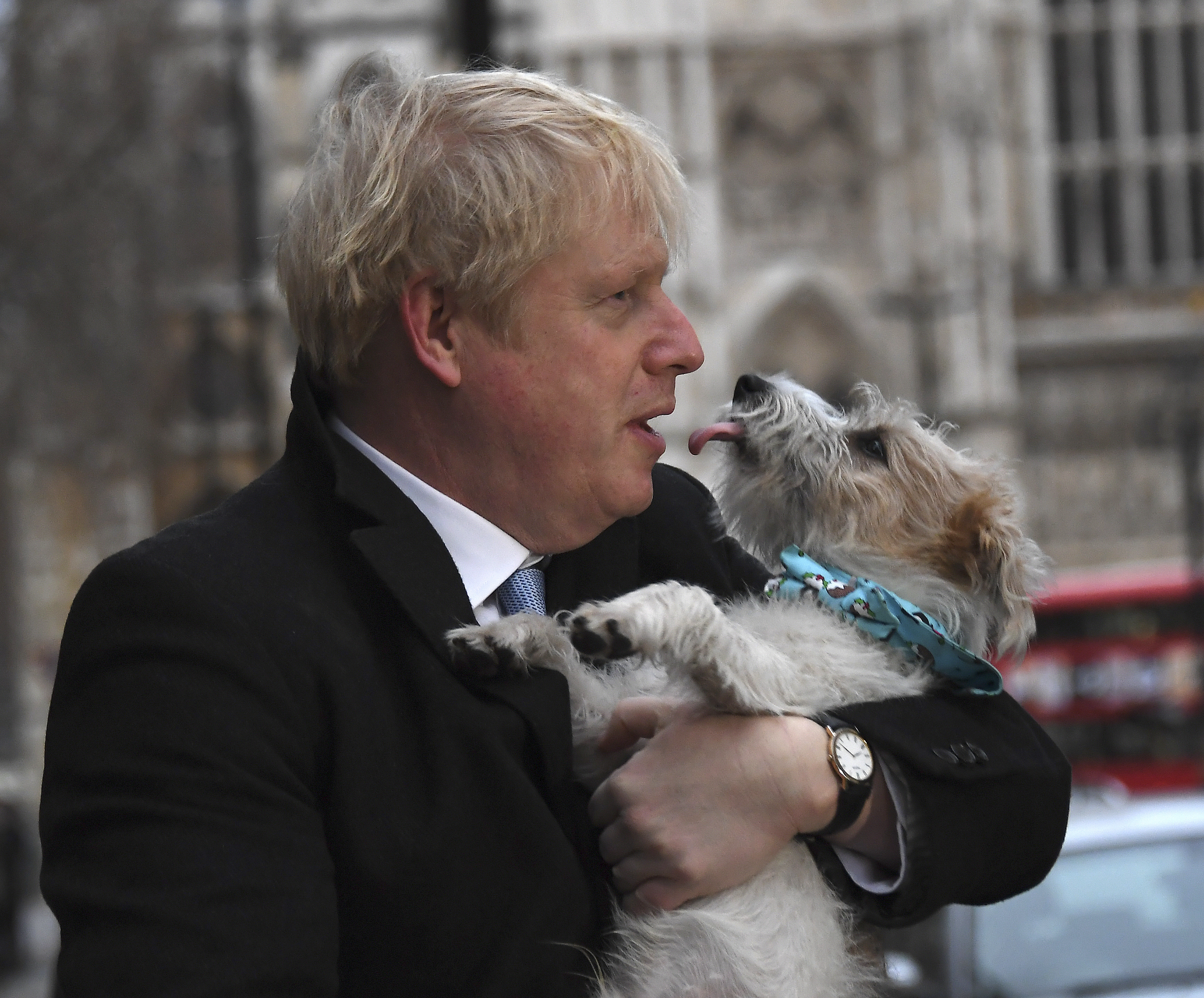 Britain's Prime Minister and Conservative Party leader Boris Johnson holds his dog Dilyn after voting in the general election at Methodist Central Hall in London, on Thursday.