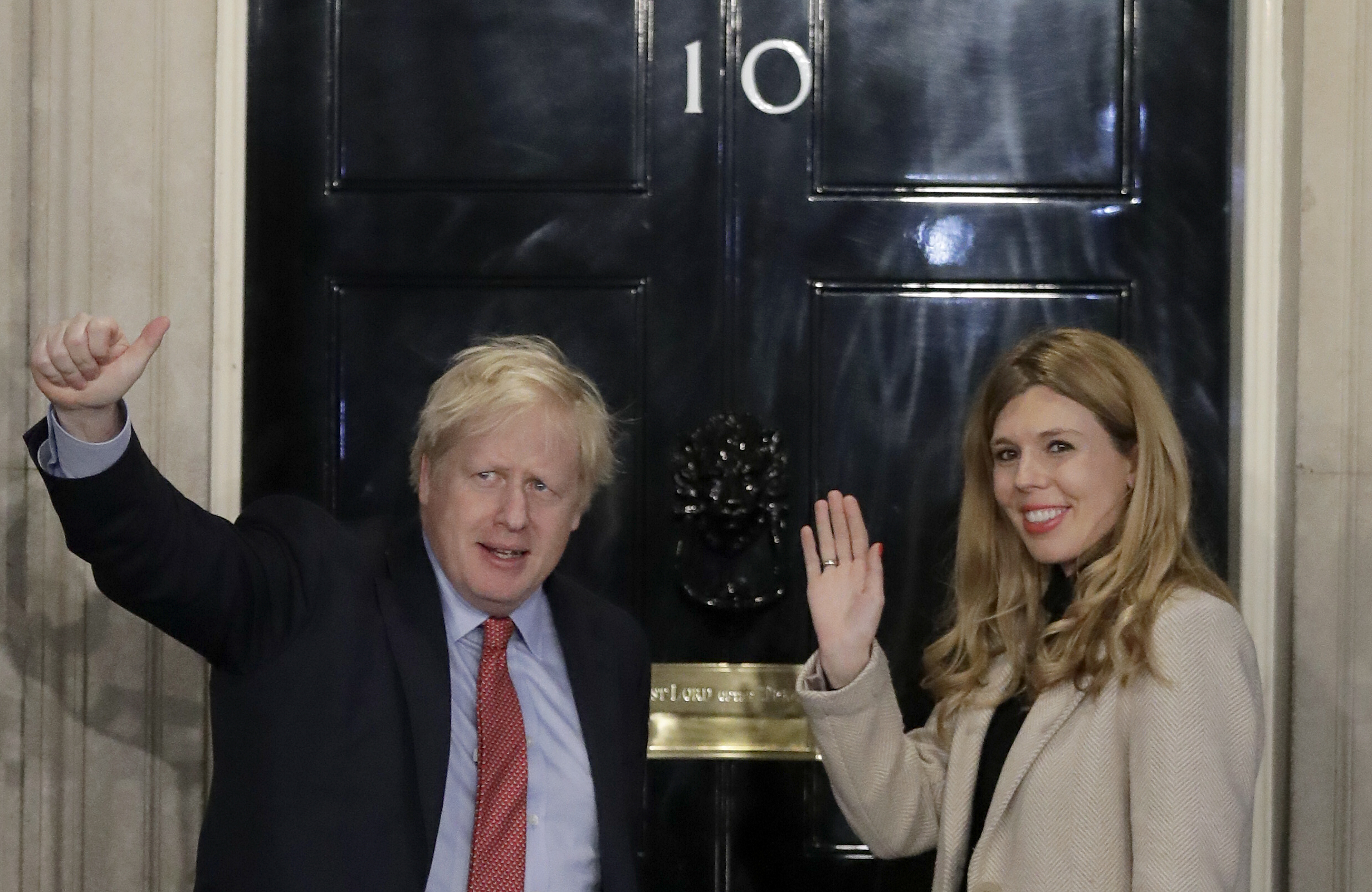 Britain's Prime Minister Boris Johnson and his partner Carrie Symonds wave from the steps of number 10 Downing Street in London, on Friday.