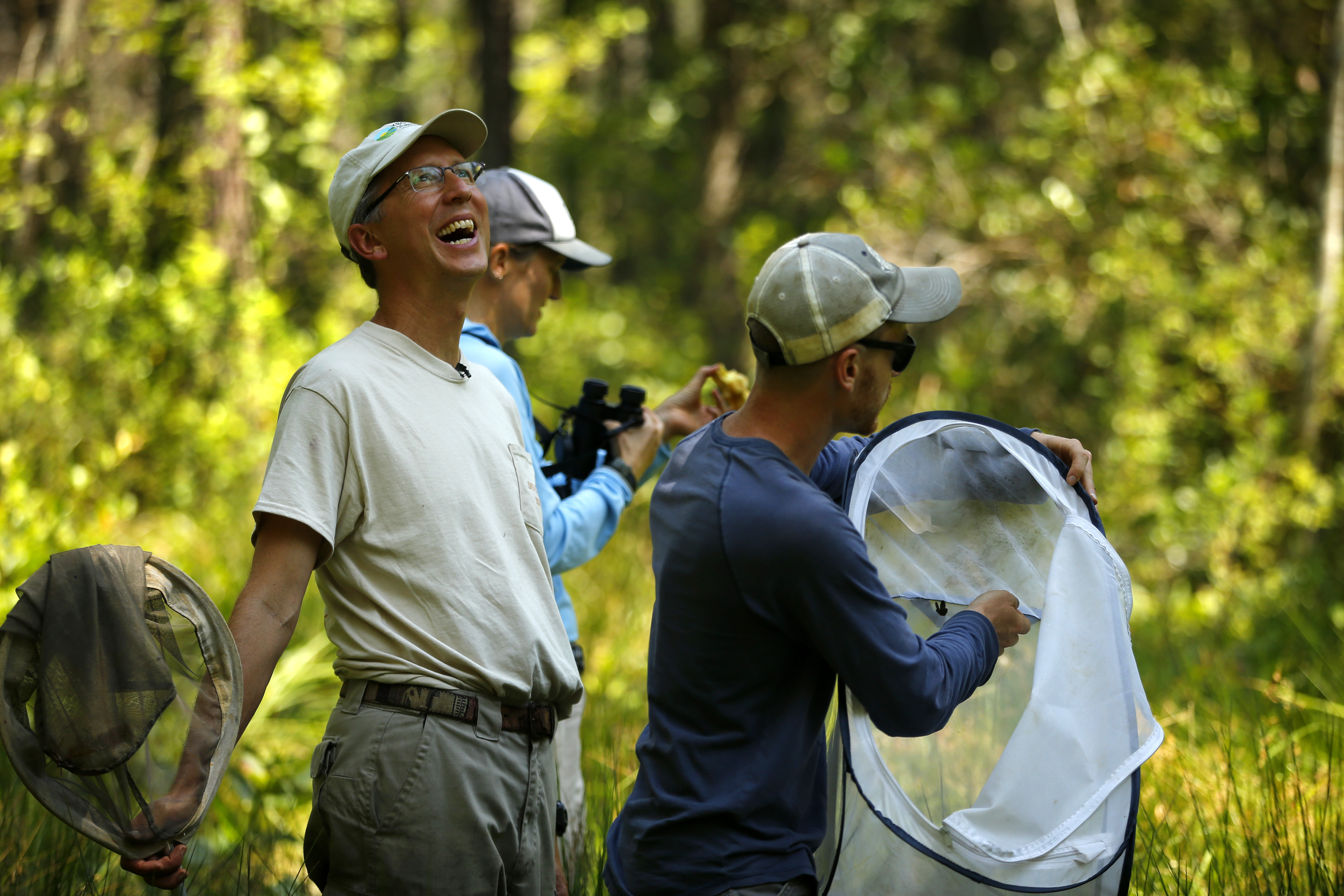 Nick Haddad, left, watches a captive-bred female St. Francis' satyr butterfly fly off after it was released into the wild at Fort Bragg in North Carolina.