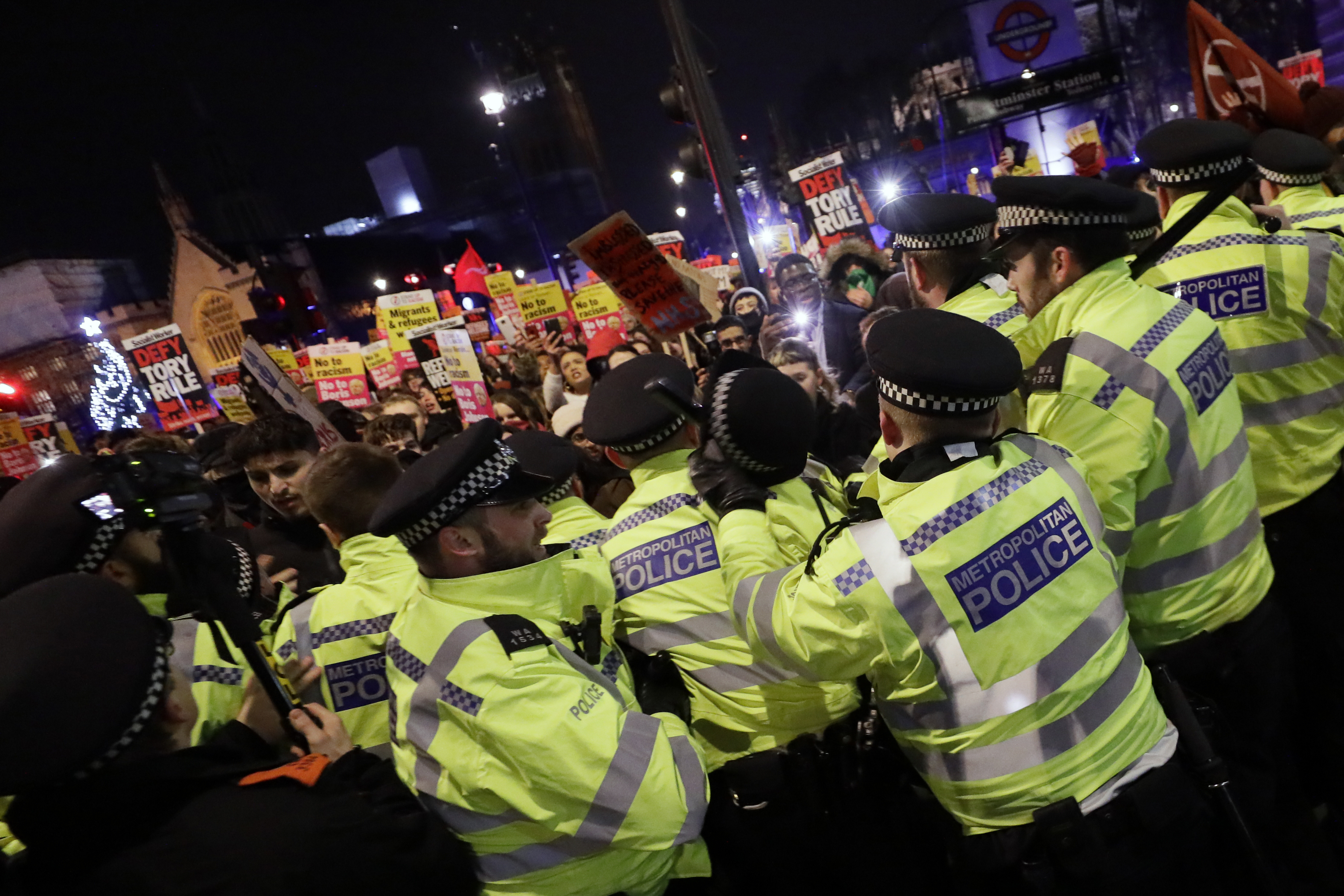 People scuffle with police during an anti-Boris Johnson demonstration at Trafalgar Square in central London, on Friday.