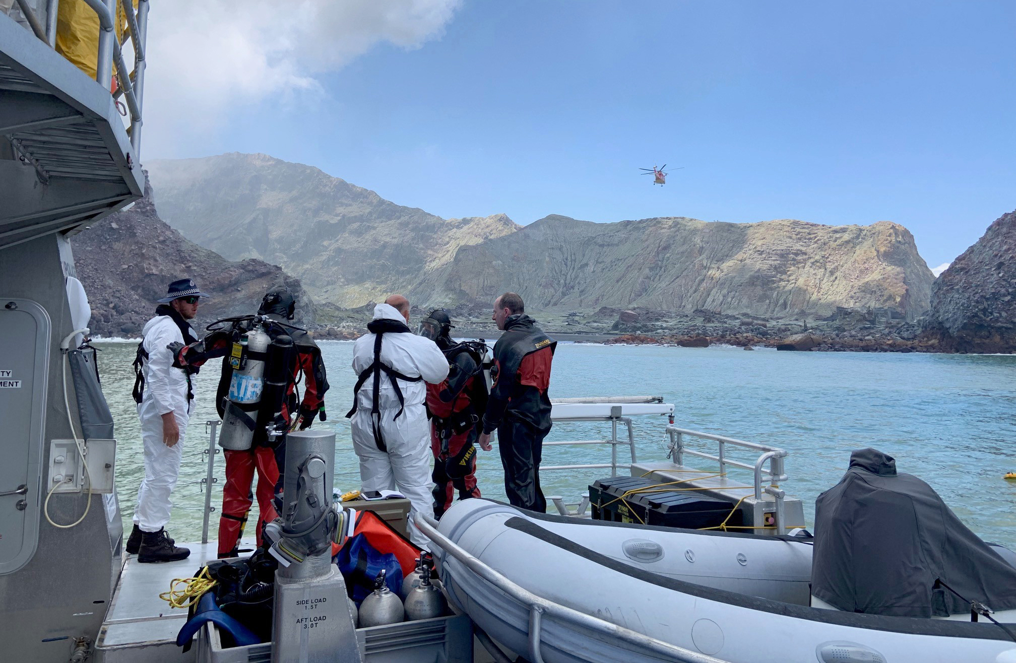 Police divers prepare to search the waters near White Island off the coast of Whakatane, New Zealand.