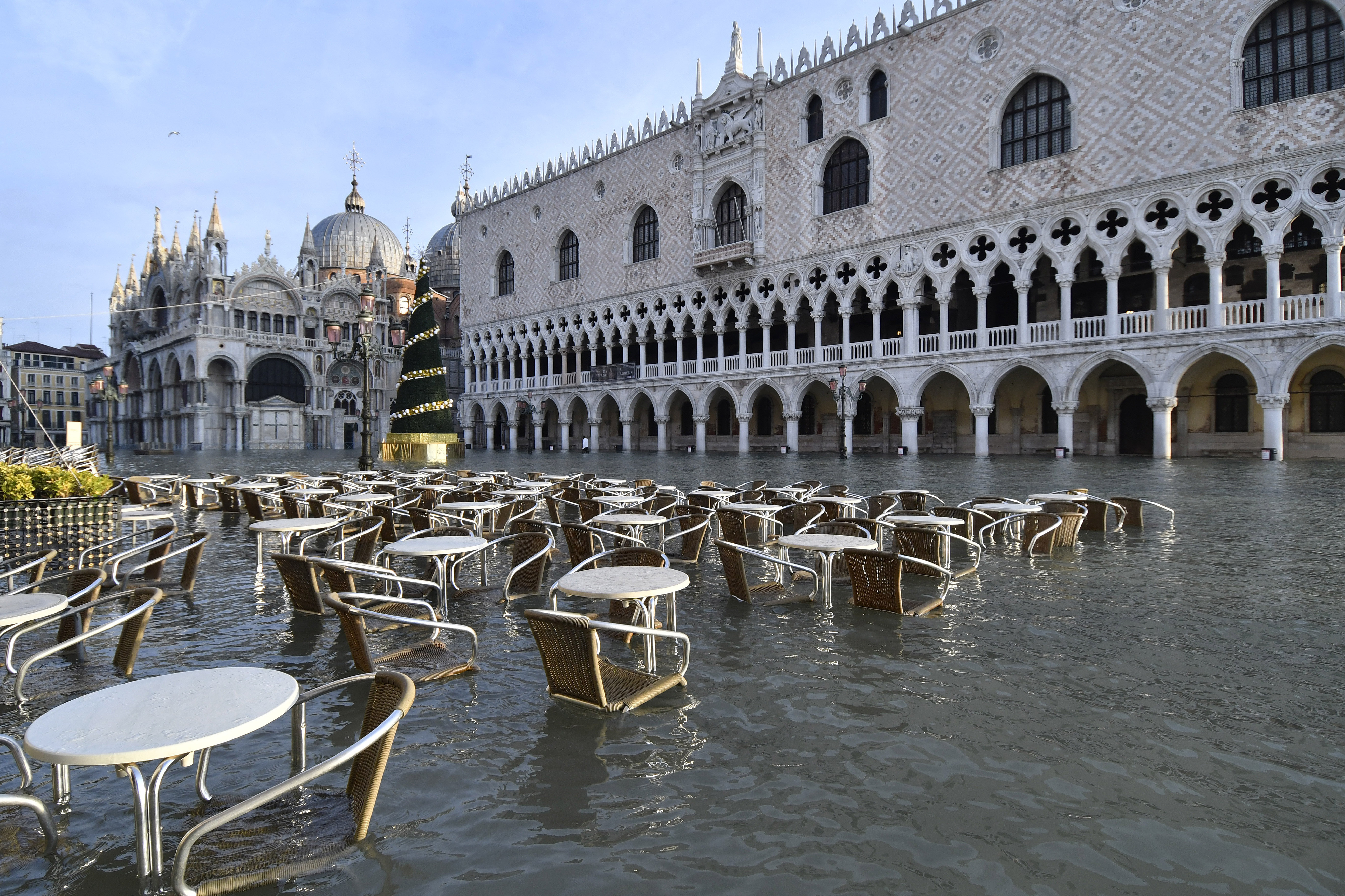 Cafè tables and chairs are partially covered in water during a high tide of 1.44 meters in St. Mark's Square, in Venice.