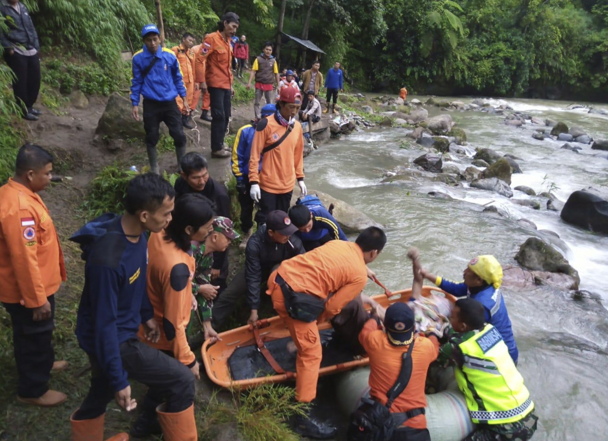 Rescuers removing the body of a victim of a bus accident in Pagaralam, Indonesia, on Tuesday.