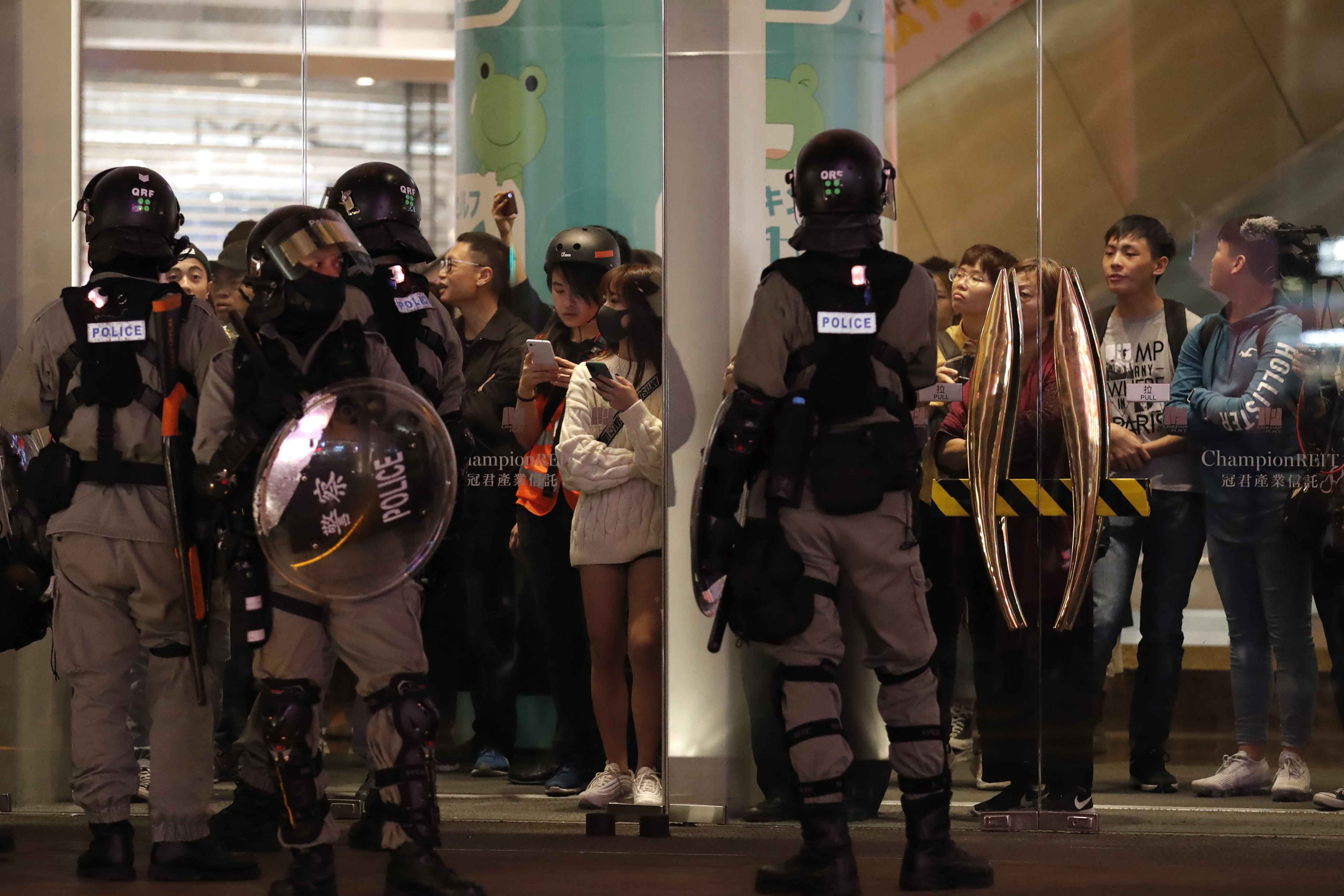 Riot police gather near a shopping mall during a demonstration in Hong Kong, on Thursday.