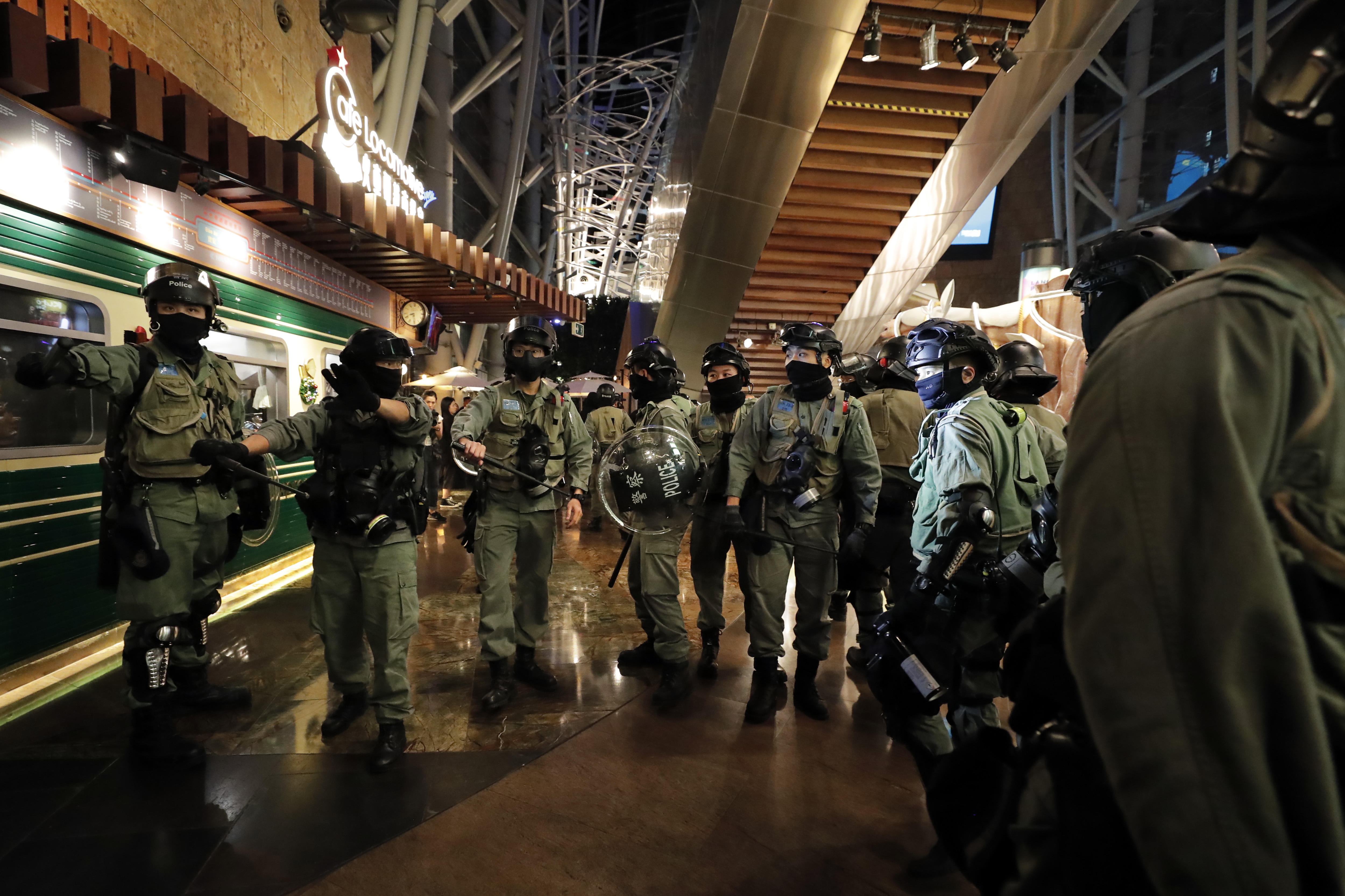 Riot police gather near a shopping mall during a demonstration in Hong Kong, on Thursday.