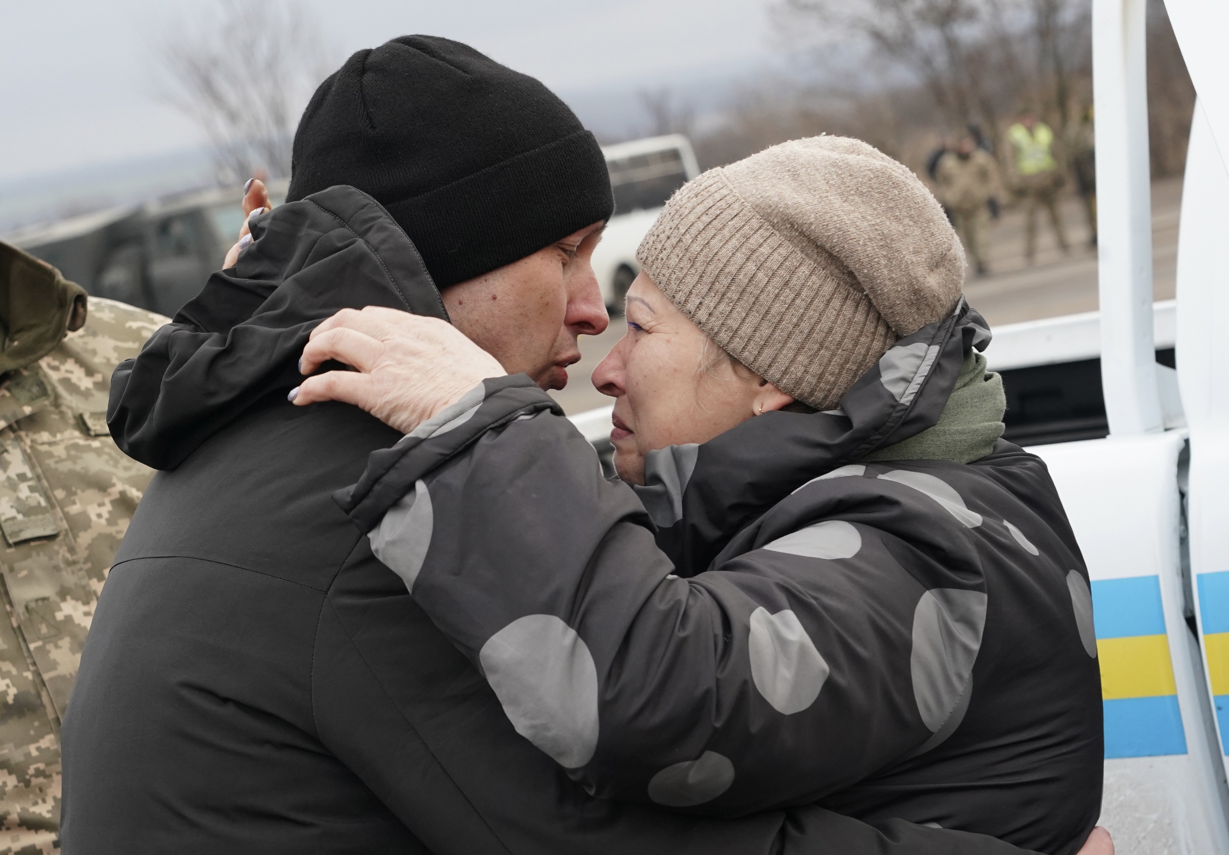 A Ukrainian war prisoner embraces his mother after been released after a prisoner exchange, near Odradivka, eastern Ukraine, Sunday.