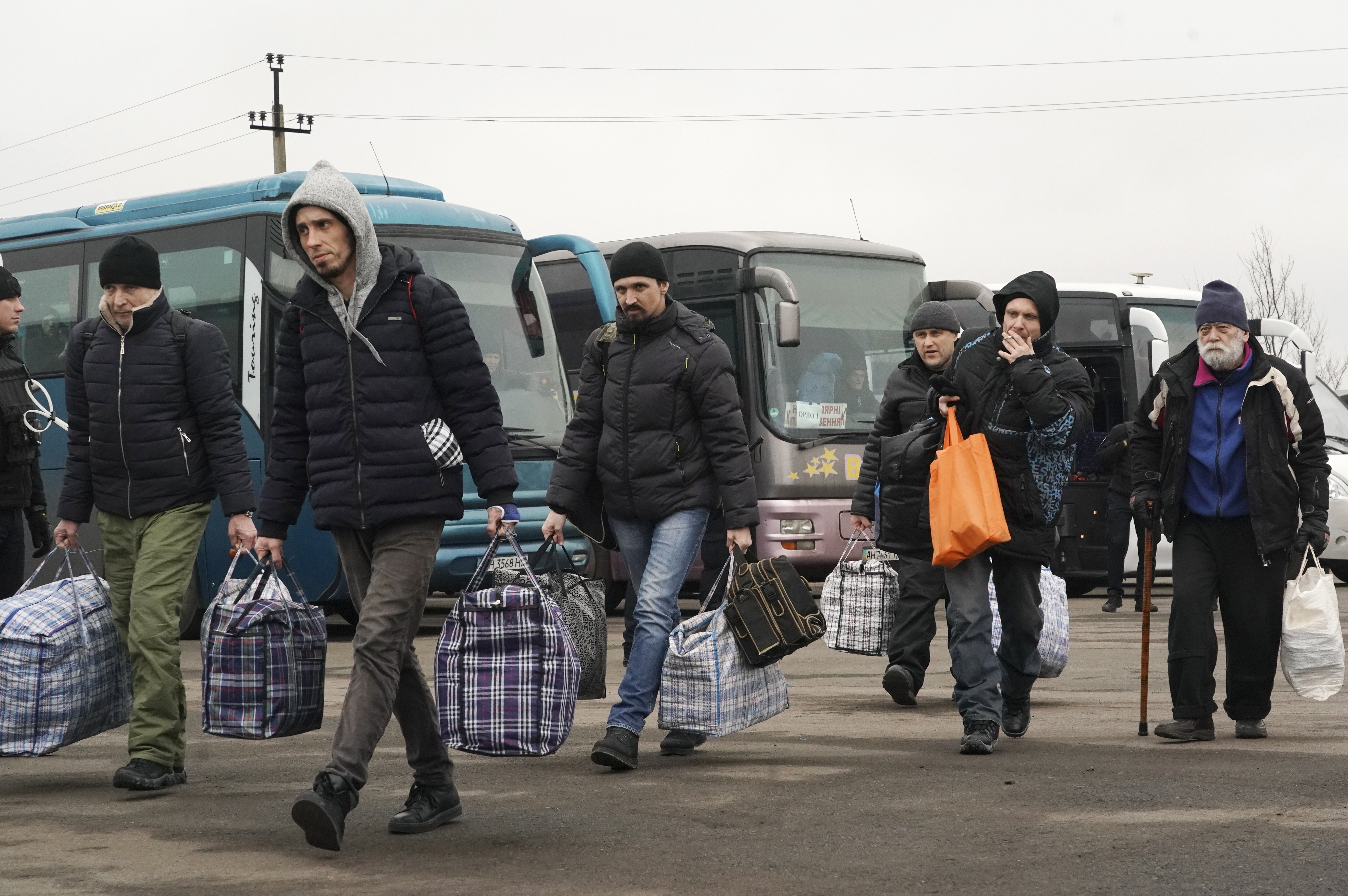 Russia-backed separatists war prisoners walk after being released after a prisoner exchange, near Odradivka, eastern Ukraine, on Sunday.