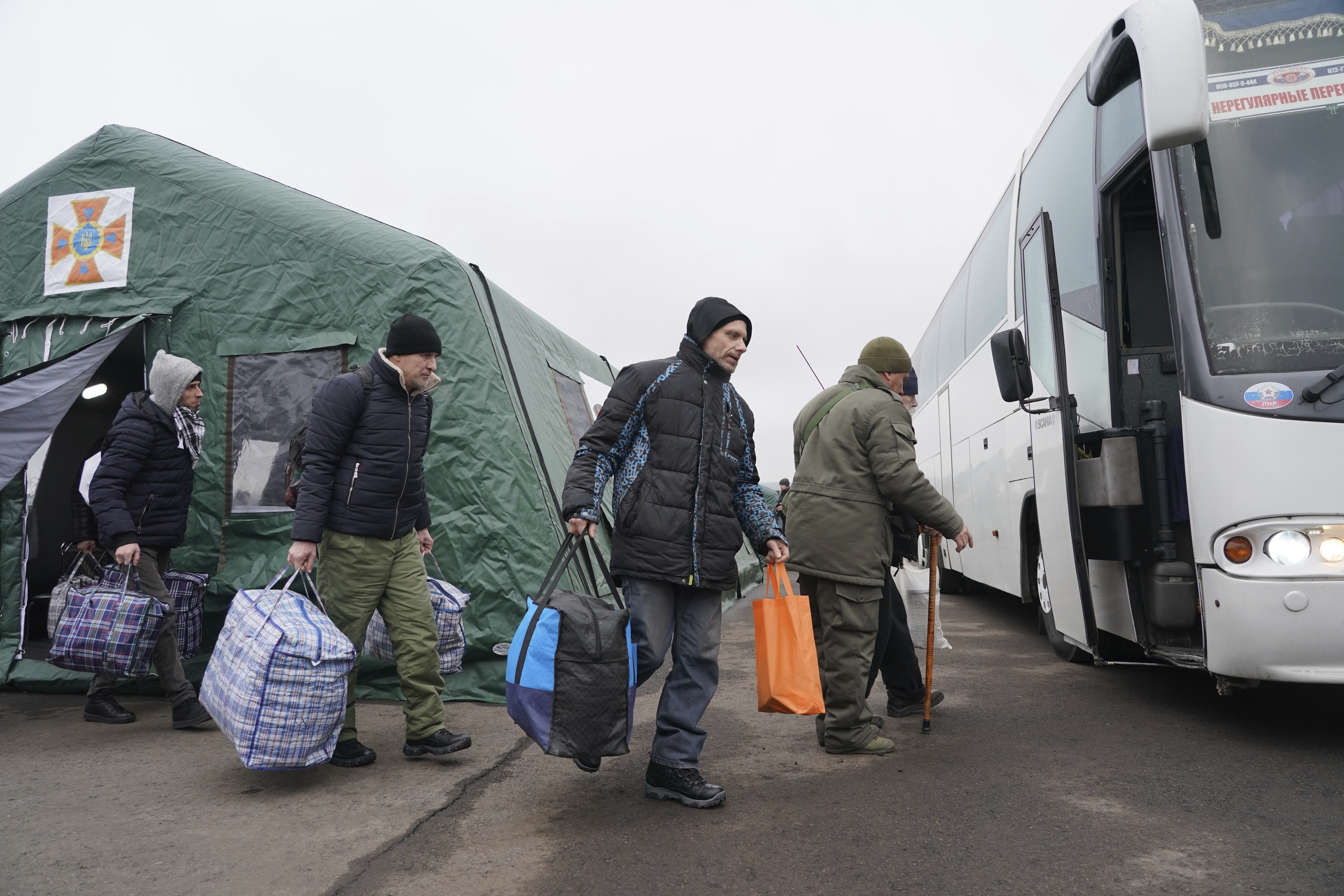 Russia-backed separatists war prisoners walk after being released after a prisoner exchange, near Odradivka, eastern Ukraine, on Sunday.