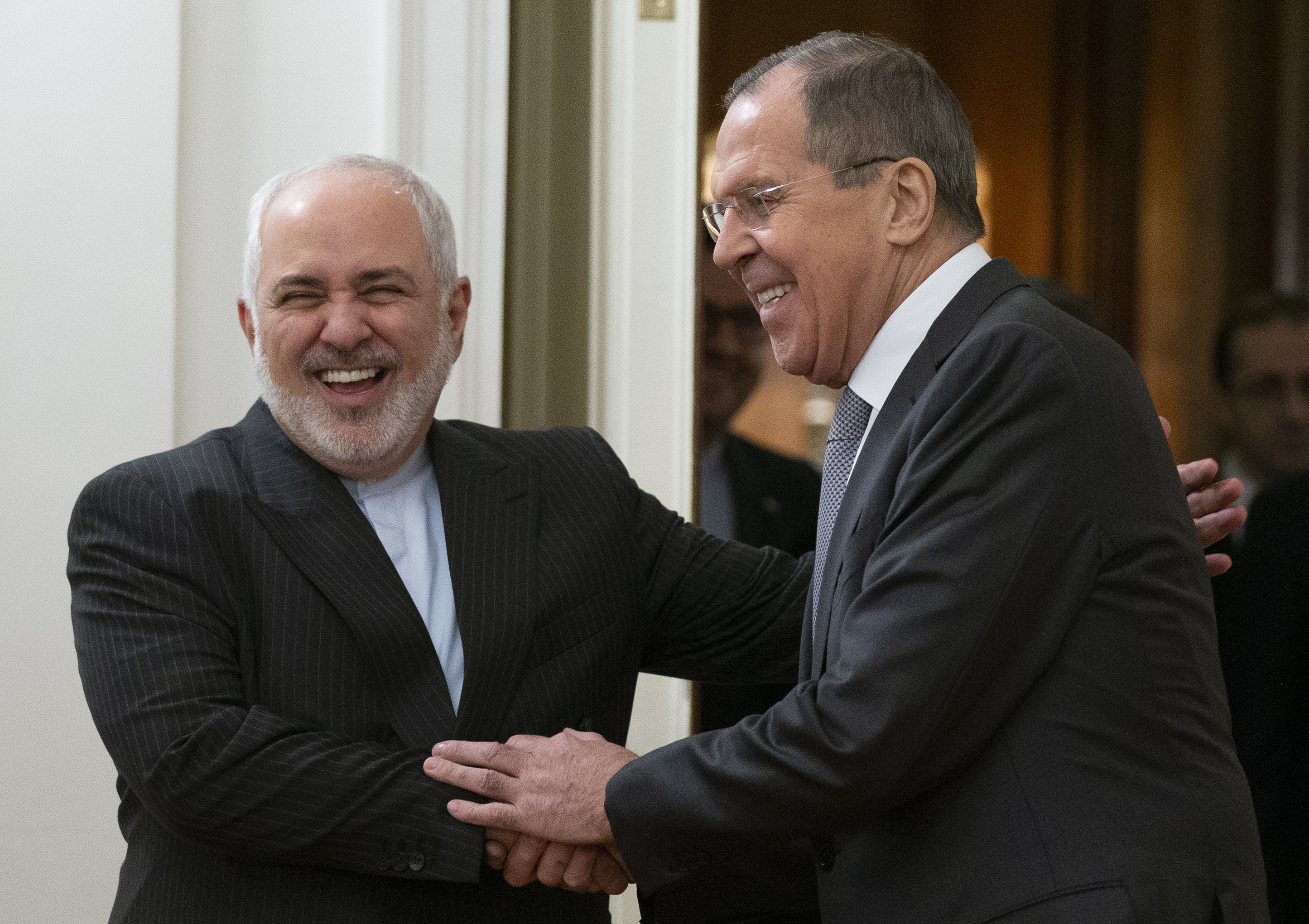 Russian Foreign Minister Sergey Lavrov, and Iranian Foreign Minister Mohammad Javad Zarif shake hands prior to their talks in Moscow, Russia, on Monday.