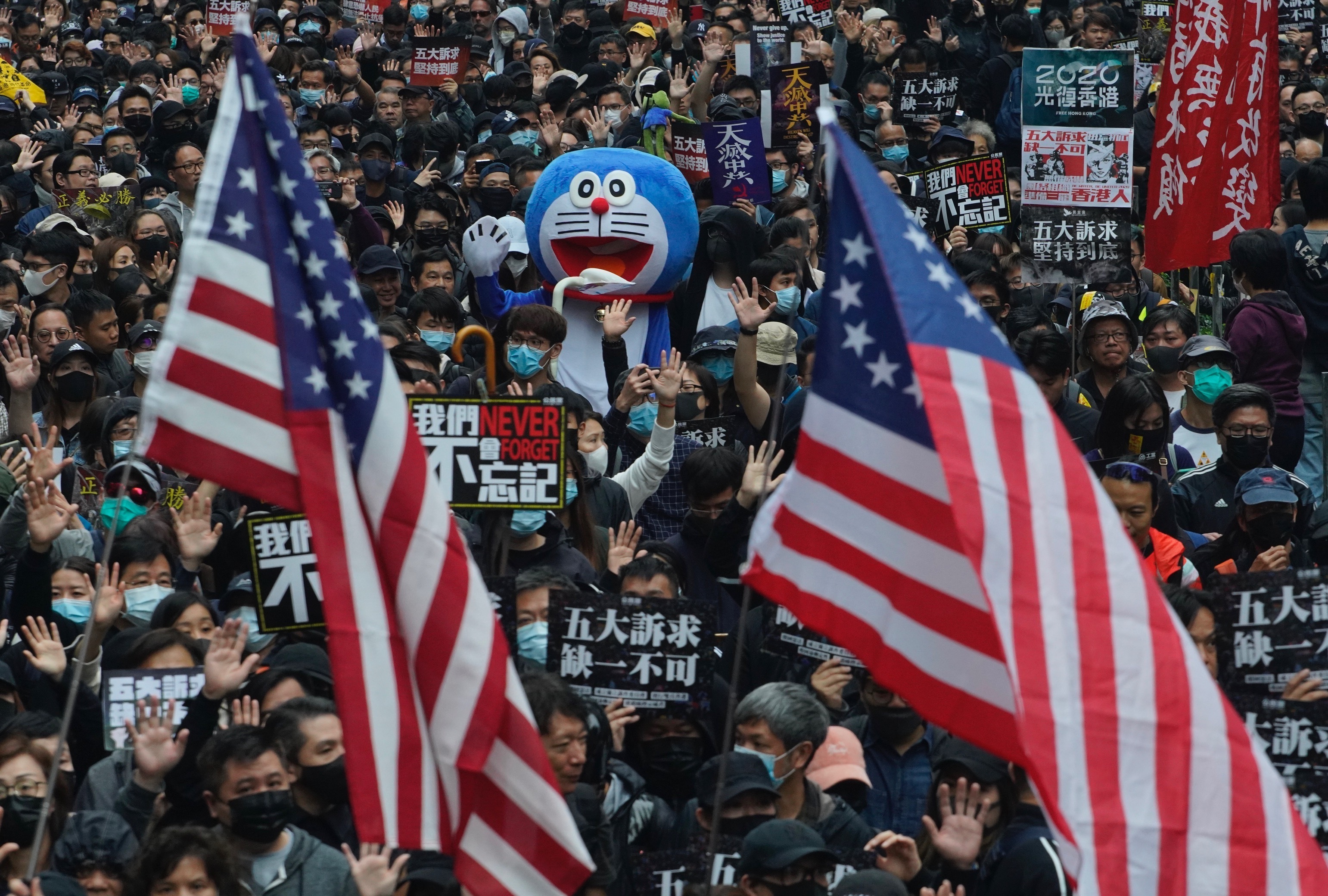 Hong Kong people participate in their annual pro-democracy march to insist their five demands be matched by the government in Hong Kong, on Wednesday.