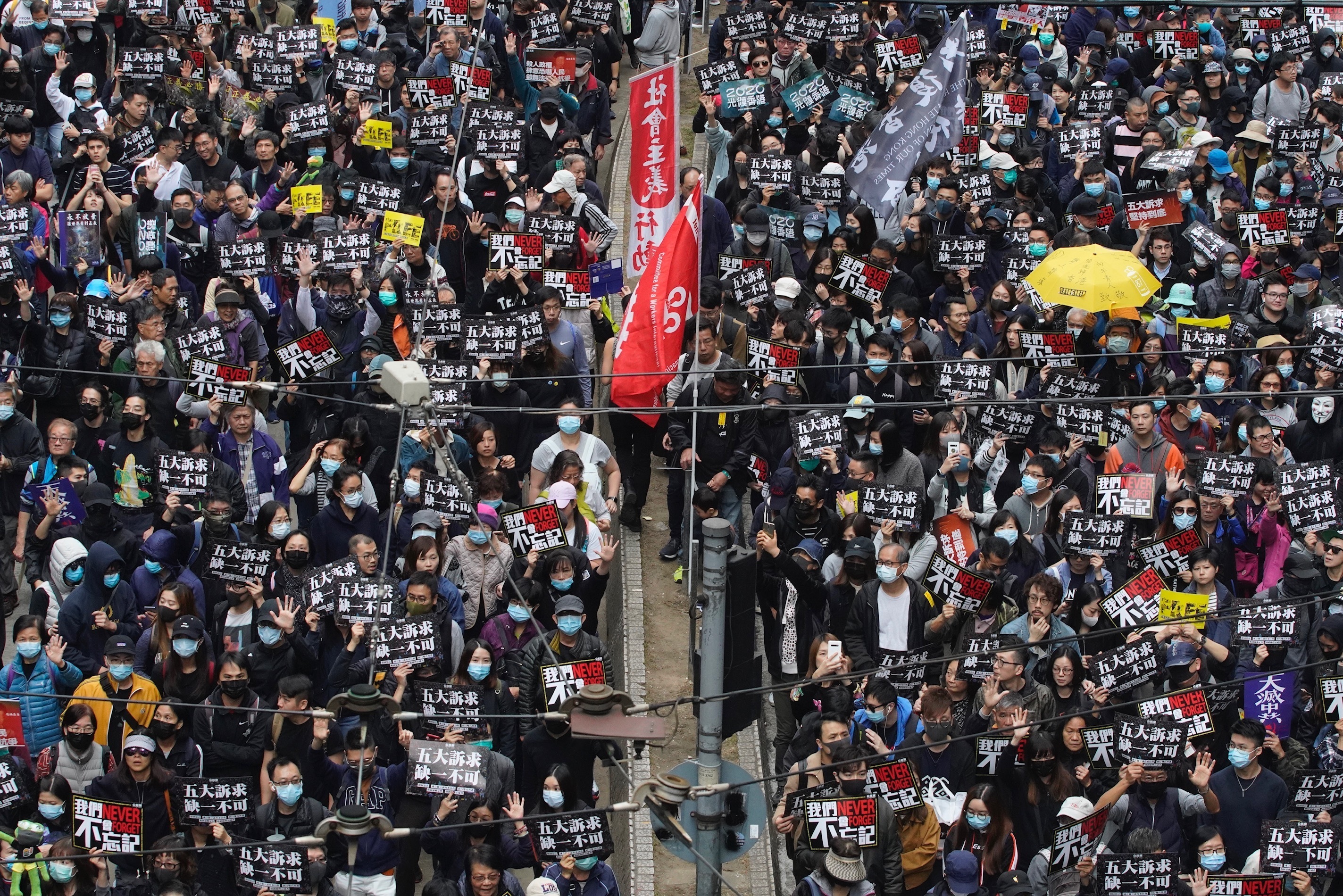 Hong Kong people participate in their annual pro-democracy march to insist their five demands be matched by the government in Hong Kong, on Wednesday.