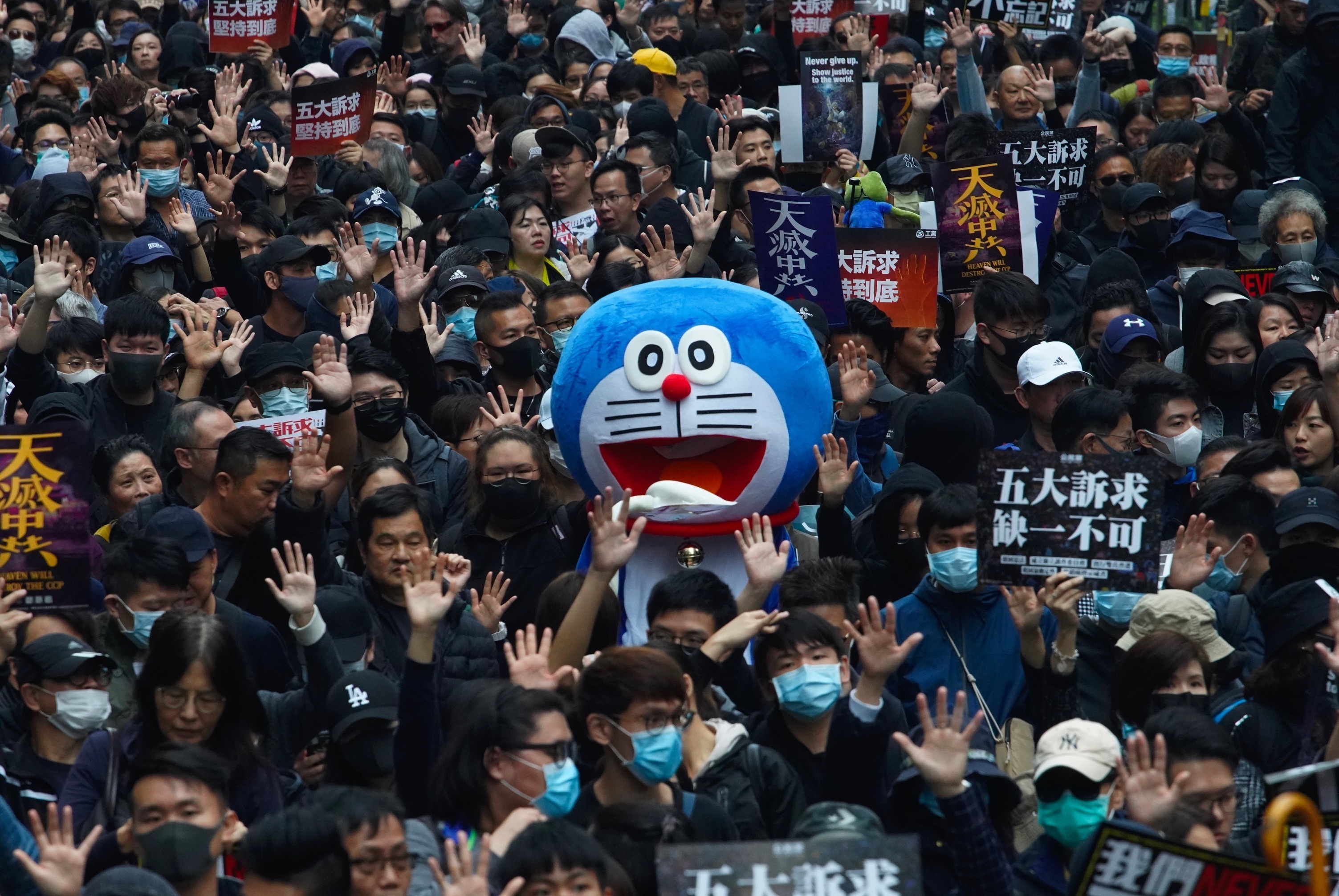 Hong Kong people participate in their annual pro-democracy march to insist their five demands be matched by the government in Hong Kong, on Wednesday.