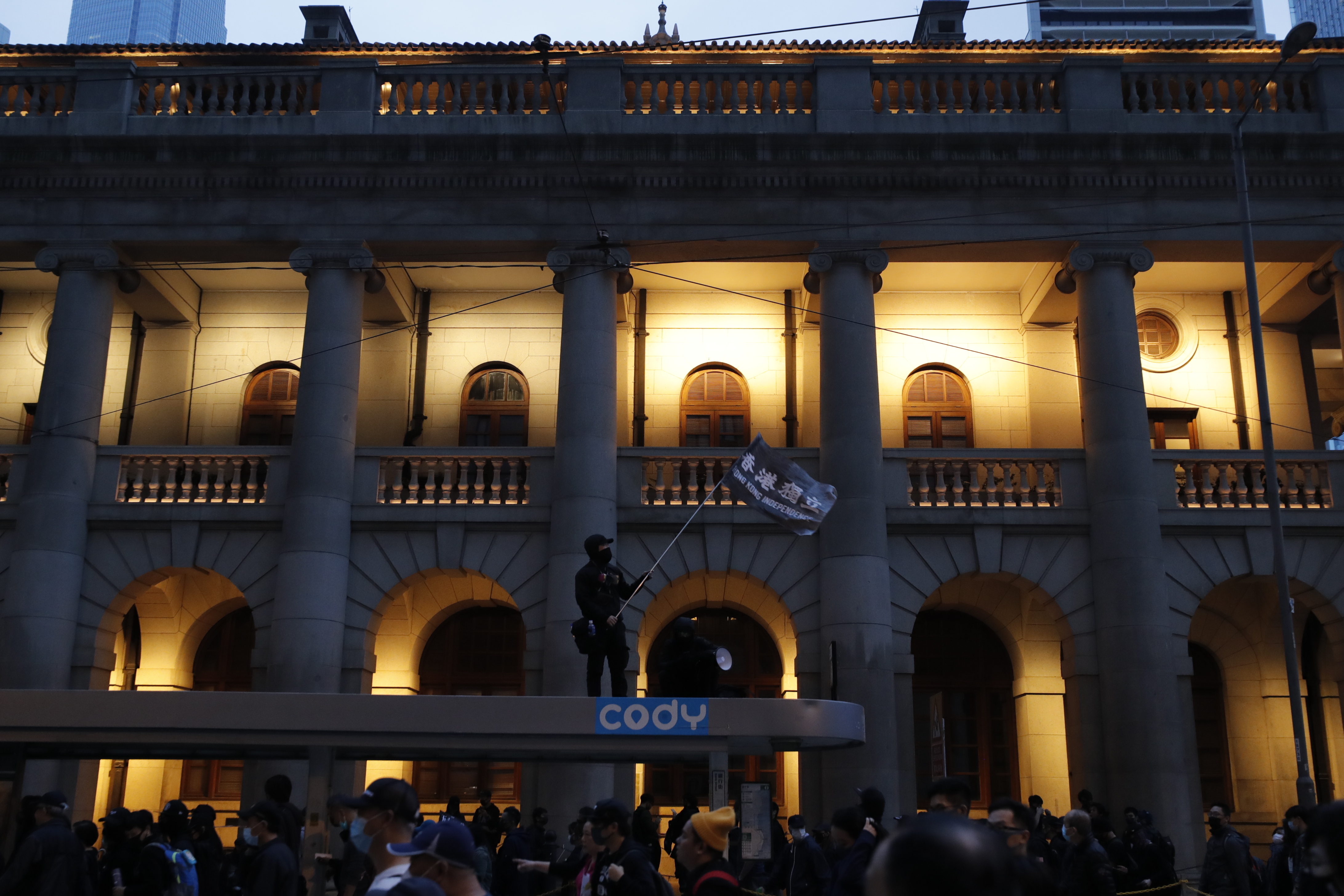 A protestor waves a flag as they leave after a massive march in Hong Kong, on Wednesday.