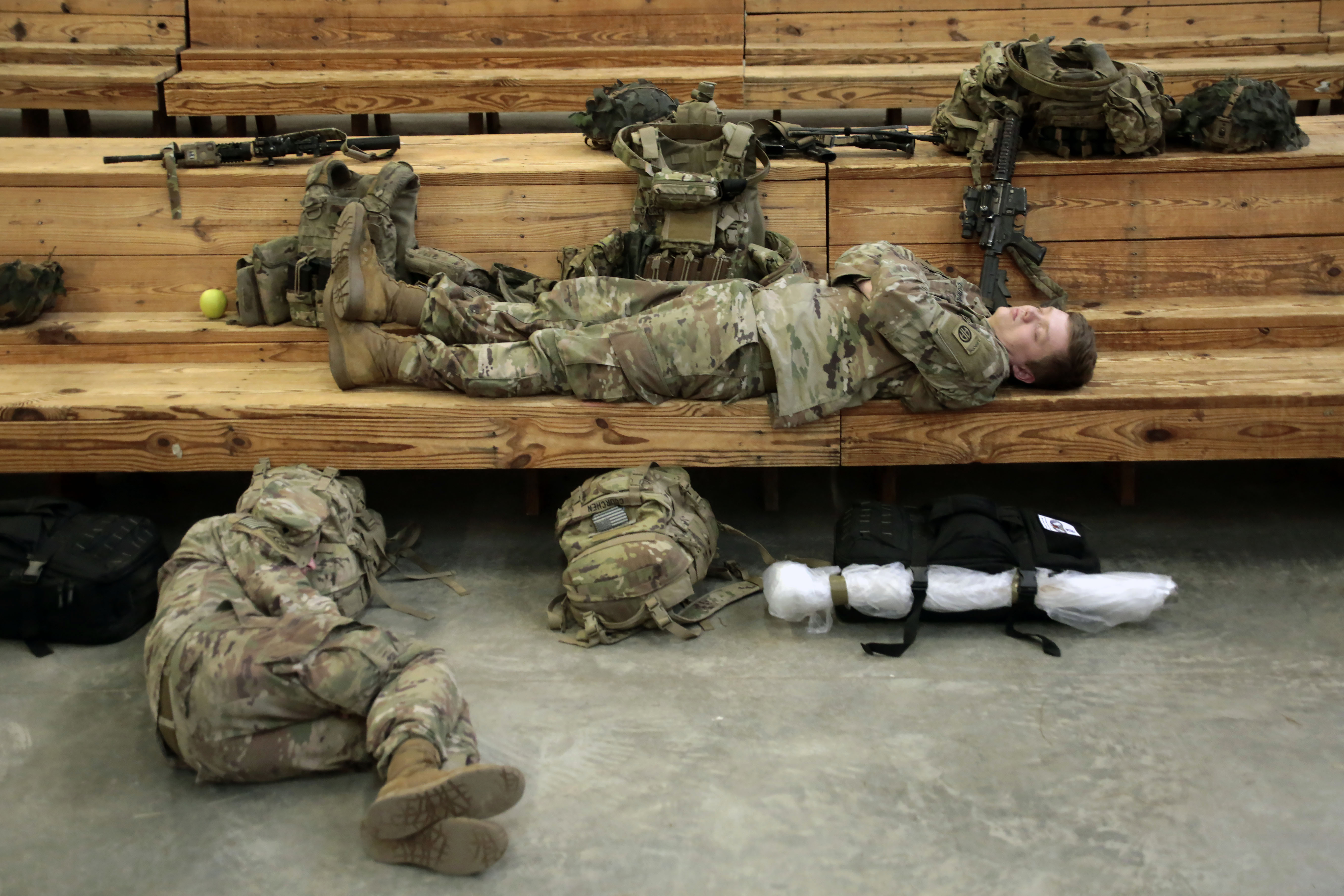 U.S. Army soldiers rest before heading out Saturday at Fort Bragg, N.C.