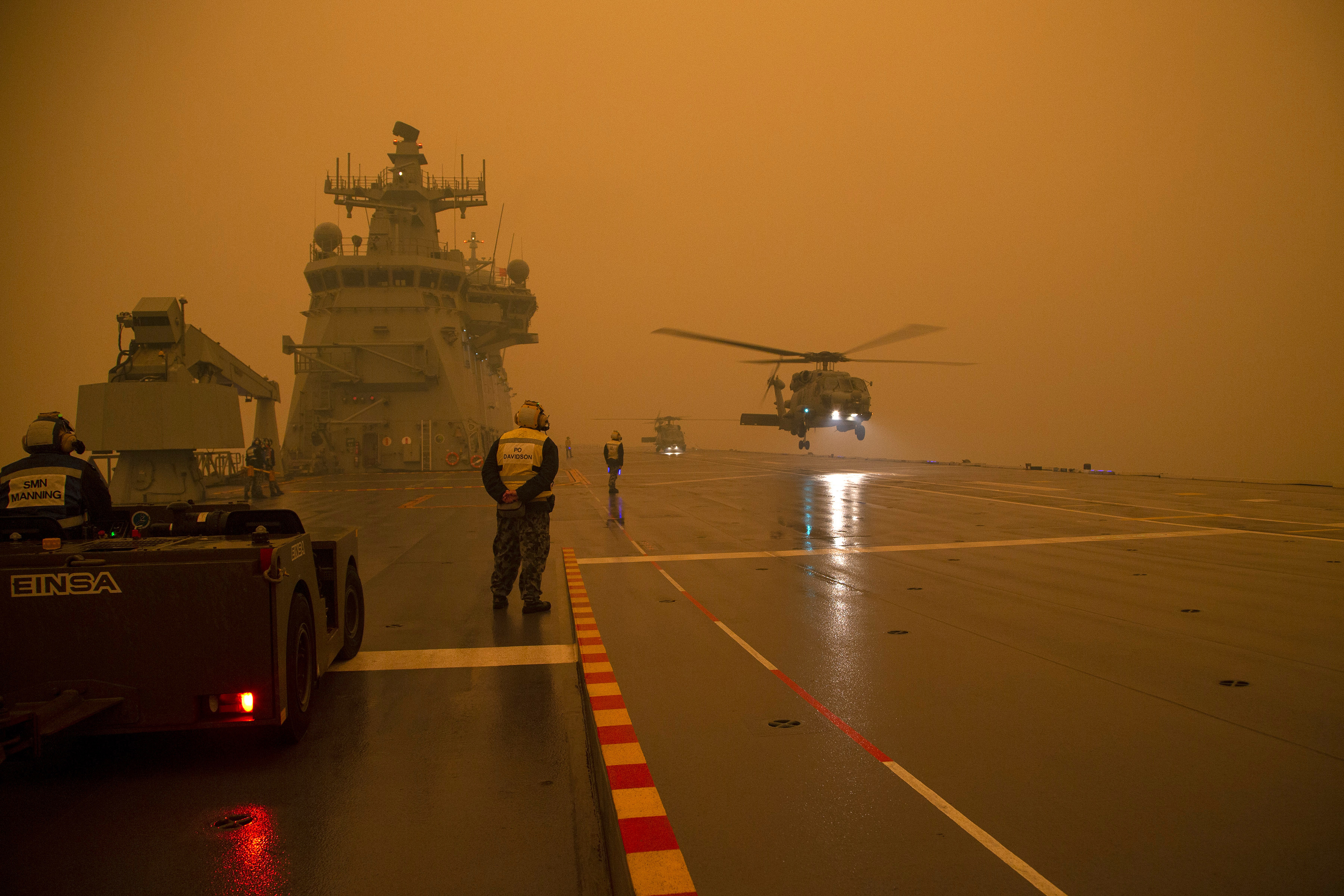 During operations to assist in battling wildfires, a Royal Australian Navy Seahawk Helicopter departs from HMAS Adelaide while at sea off Australia's east coast on Sunday.