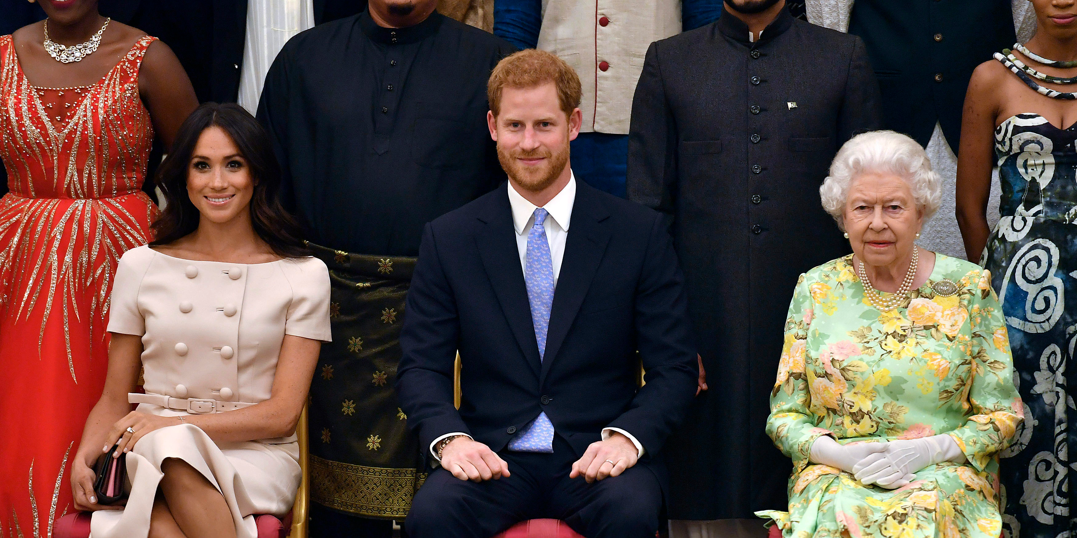 In this Tuesday, June 26, 2018 file photo Britain's Queen Elizabeth, Prince Harry and Meghan, Duchess of Sussex pose for a group photo at the Queen's Young Leaders Awards Ceremony at Buckingham Palace in London.