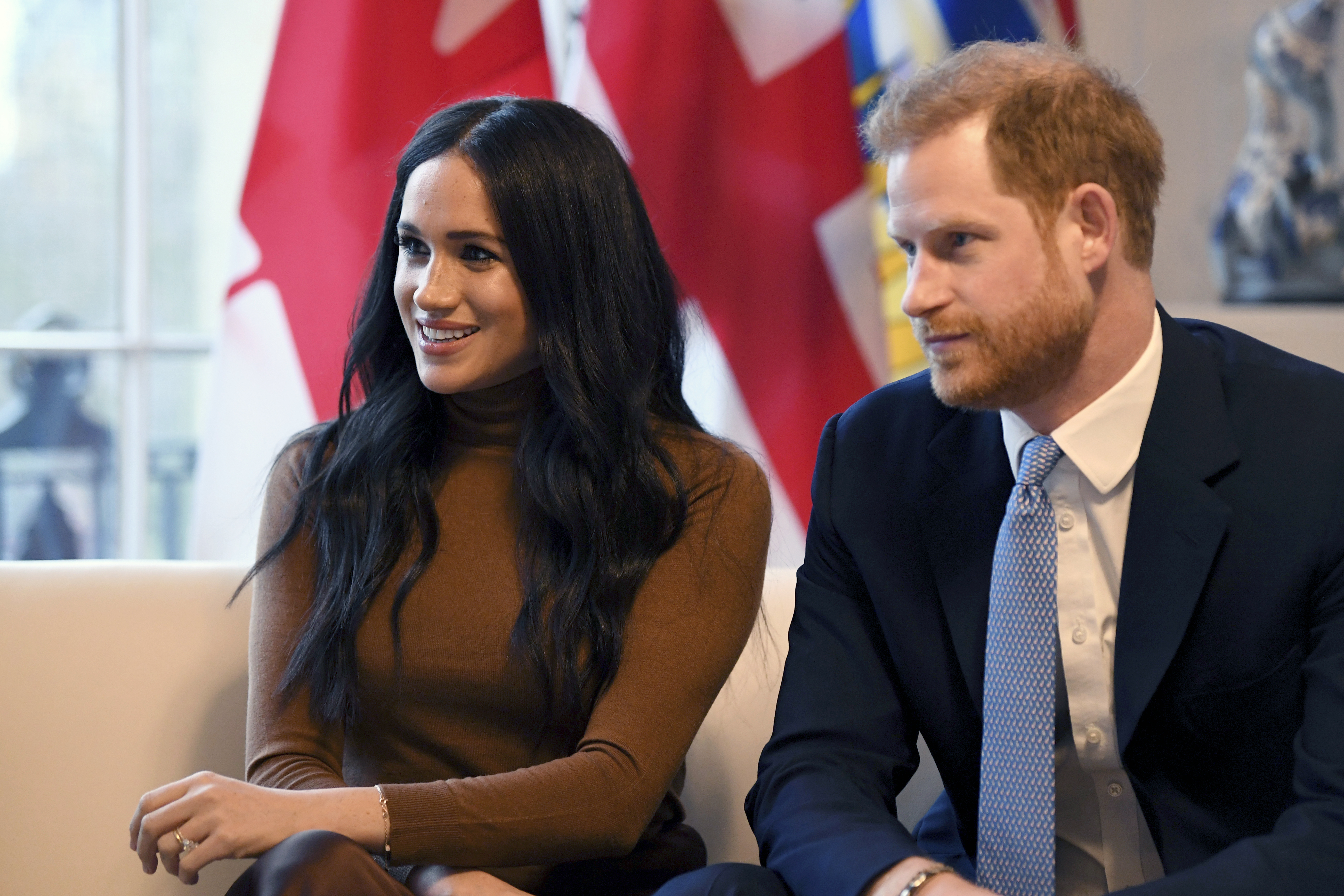 In this Tuesday, Jan. 7, 2020 file photo, Britain's Prince Harry and Meghan, Duchess of Sussex smile during their visit to Canada House, in London.