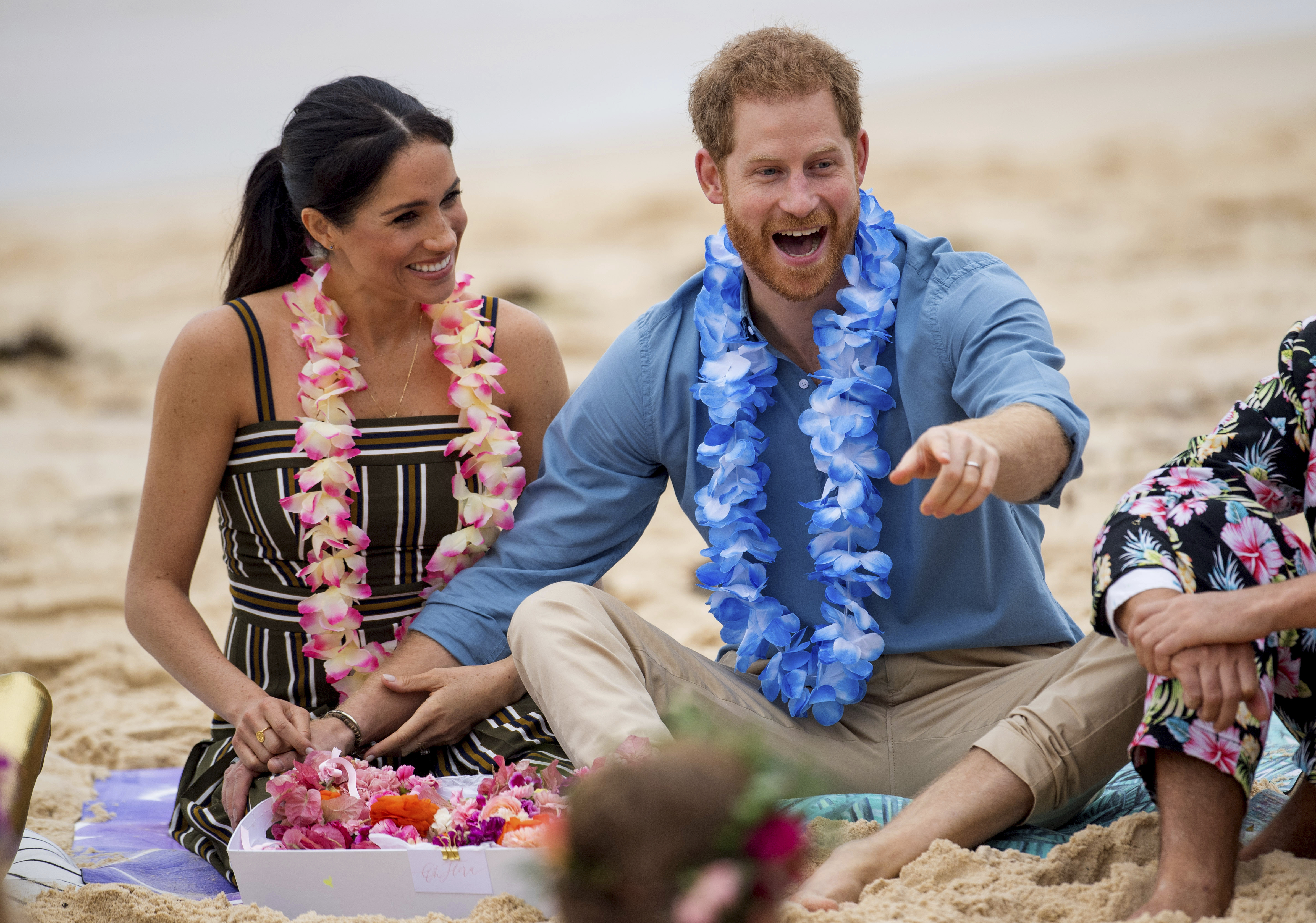 In this Friday, Oct. 19, 2018 file photo Britain's Prince Harry and Meghan, Duchess of Sussex meet with a local surfing community group, known as OneWave, raising awareness for mental health and wellbeing in a fun and engaging way at Bondi Beach in Sydney, Australia.