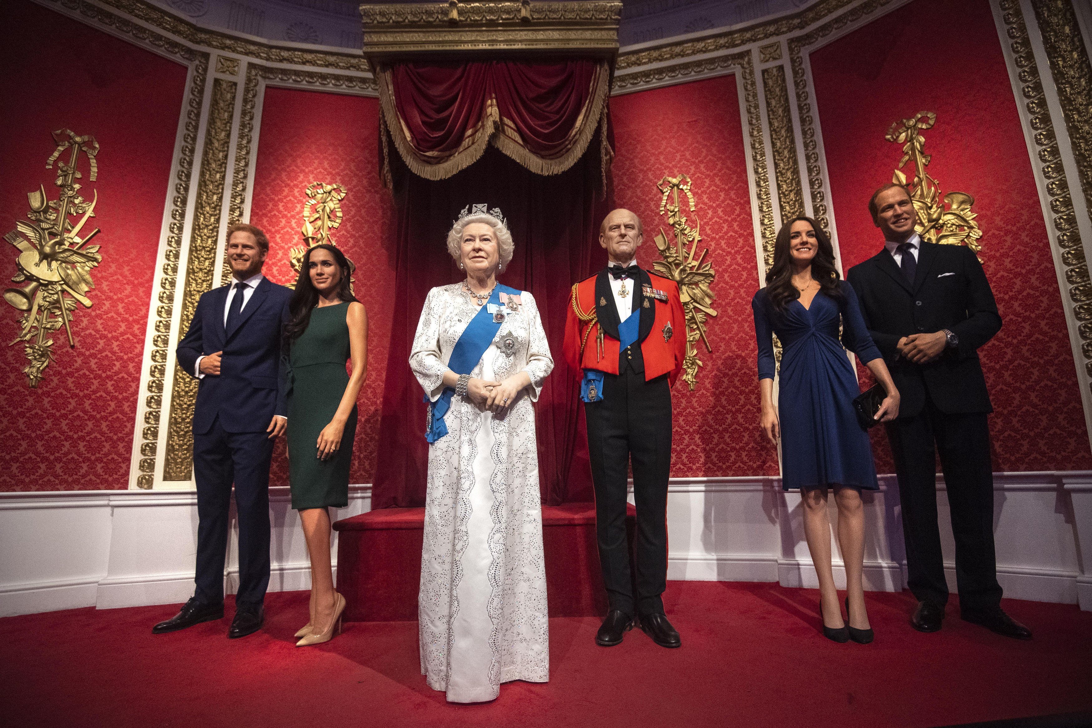 The figures of Britain's Prince Harry and Meghan, Duchess of Sussex, (left) in their original positions next to Queen Elizabeth II, Prince Philip and Prince William and Kate, Duchess of Cambridge, at Madame Tussauds in London, on Thursday.