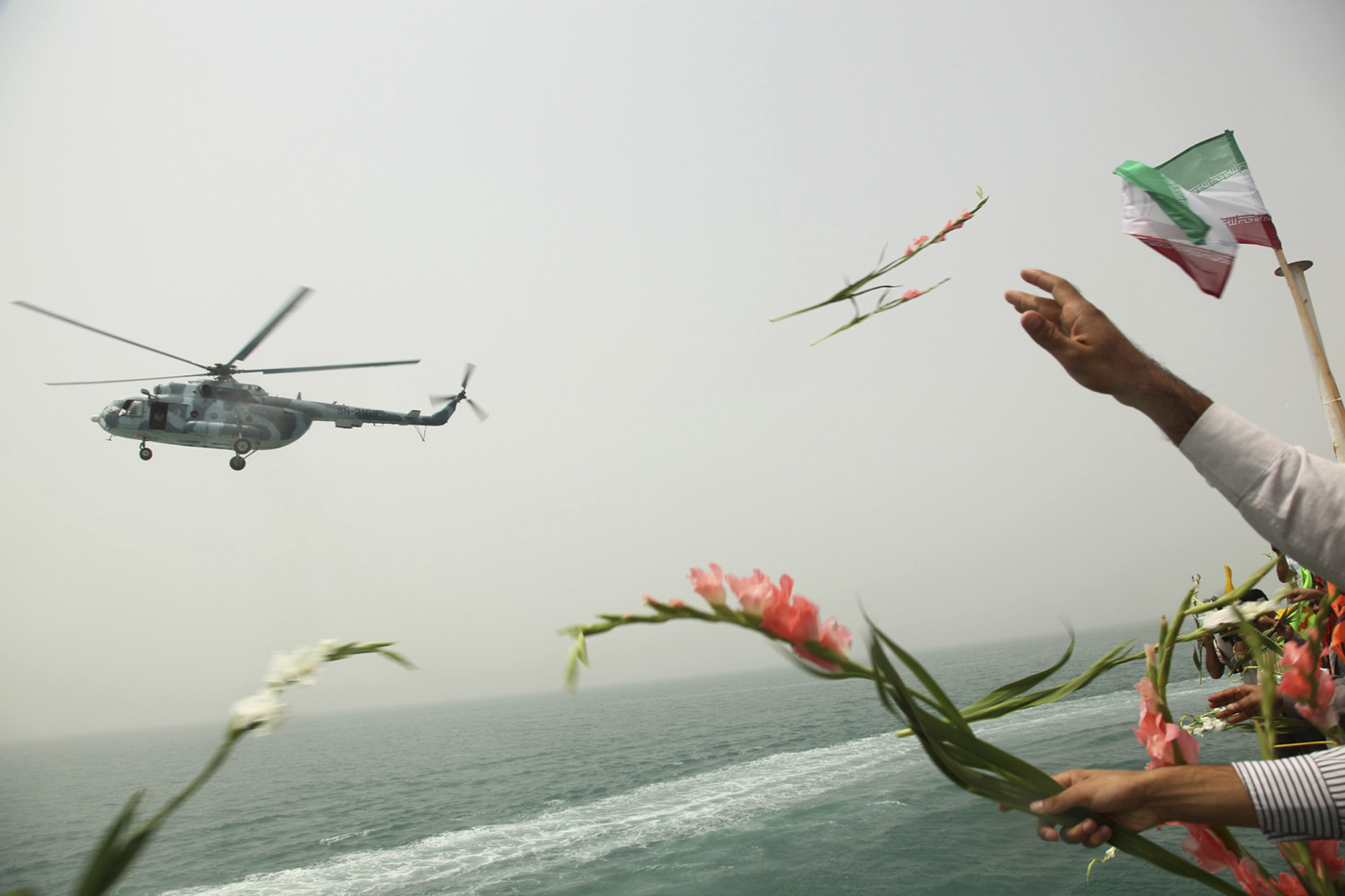 File photo: Iranians scatter flowers into the Persian Gulf at the site where an Islamic republic's passenger plane was downed by a US warship, killing all 290 aboard.