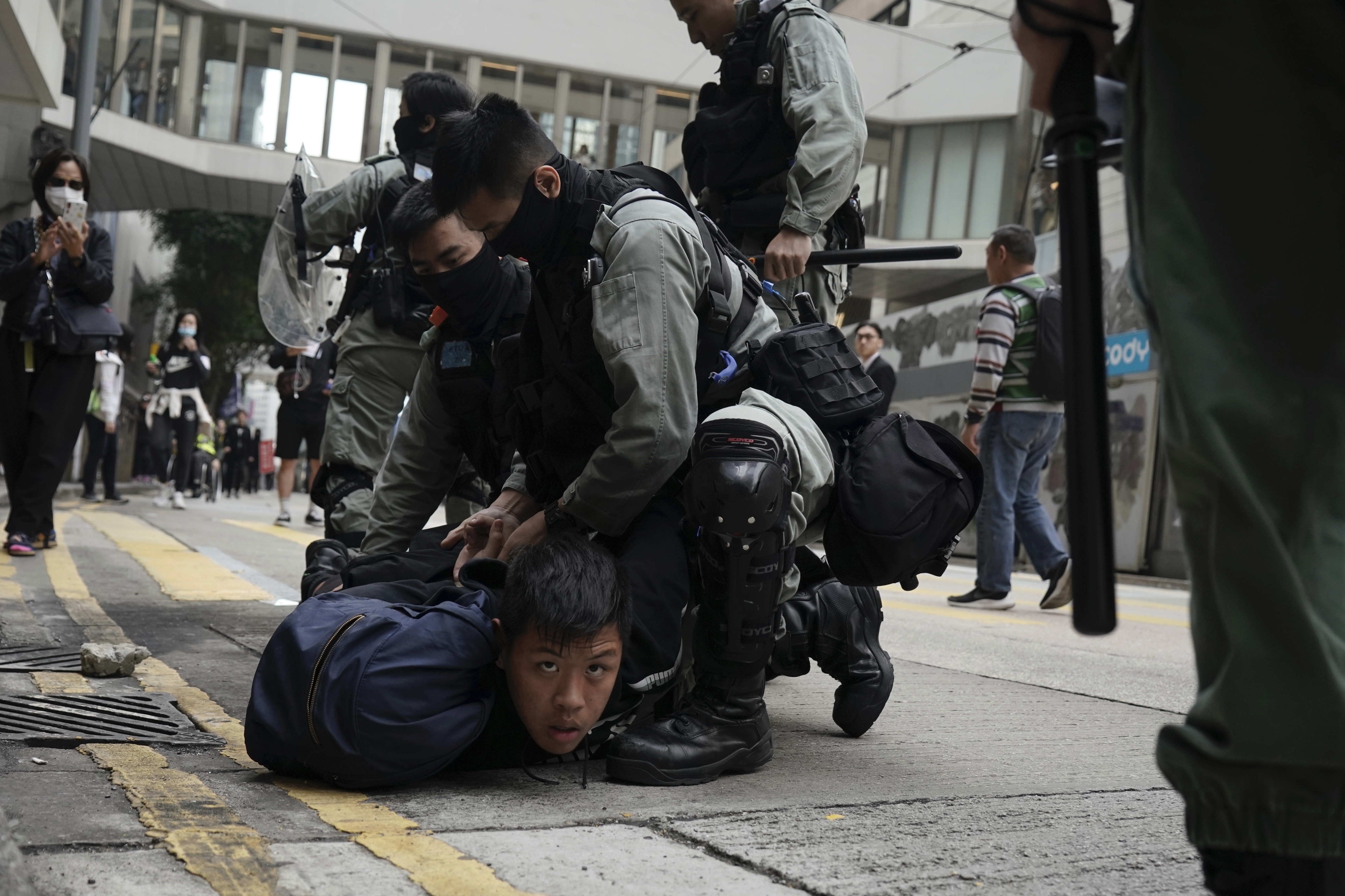 Police detain protesters calling for electoral reforms and a boycott of the Chinese Communist Party in Hong Kong, on Sunday.