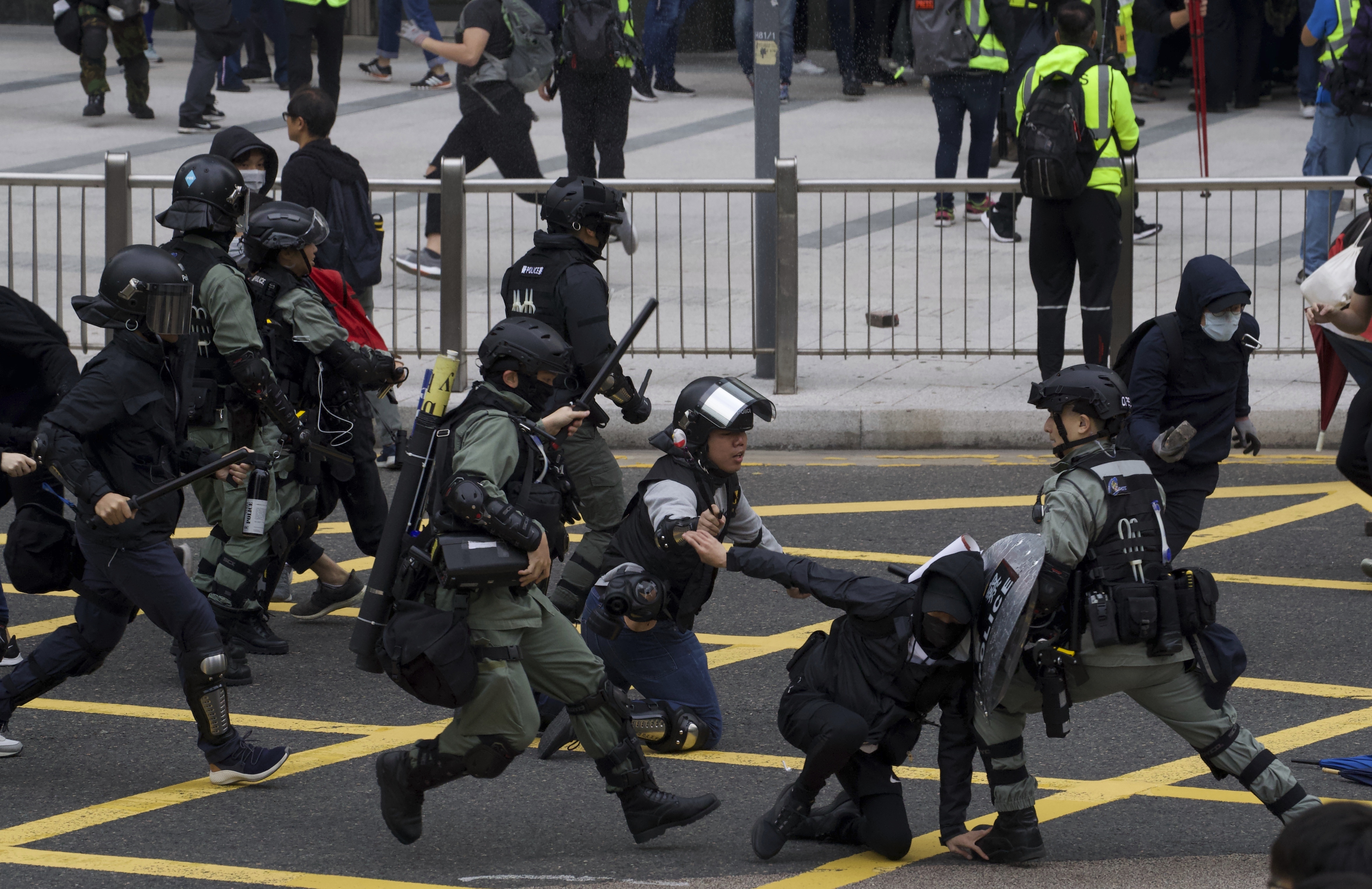 Riot police clash with protesters calling for electoral reforms and a boycott of the Chinese Communist Party in Hong Kong, on Sunday.