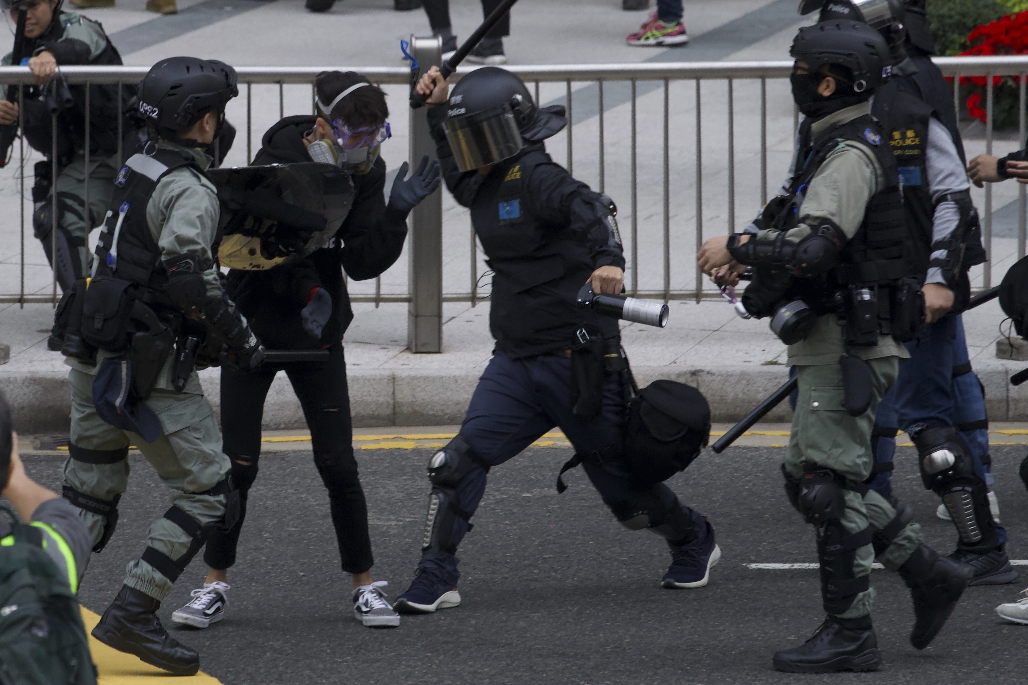 Riot police clash with protesters calling for electoral reforms and a boycott of the Chinese Communist Party in Hong Kong, on Sunday.