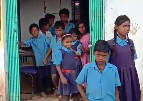 children studying in shabby school building