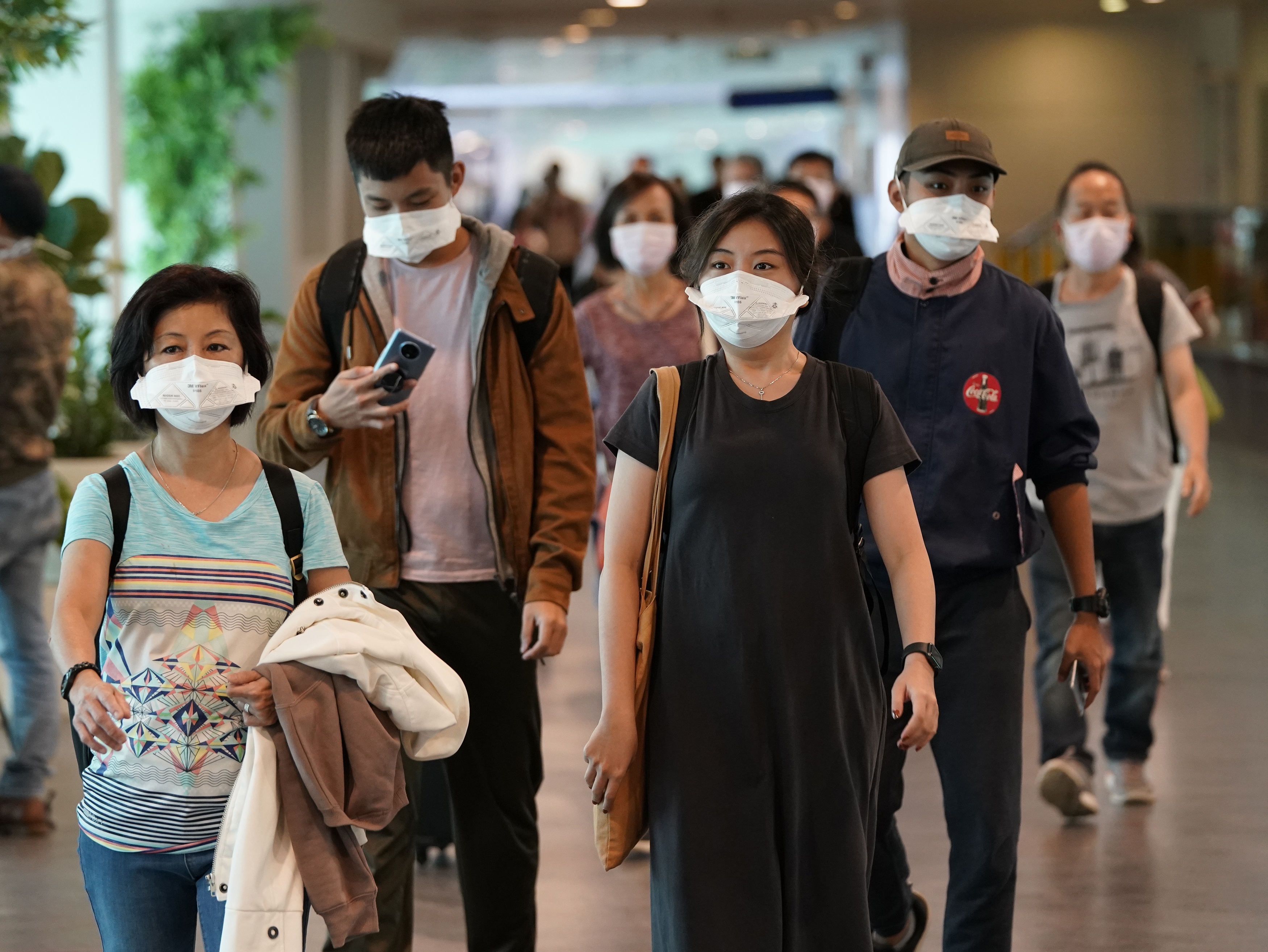 Passengers wear face mask as they arrive at Kuala Lumpur Low Cost Terminal in Sepang, Malaysia