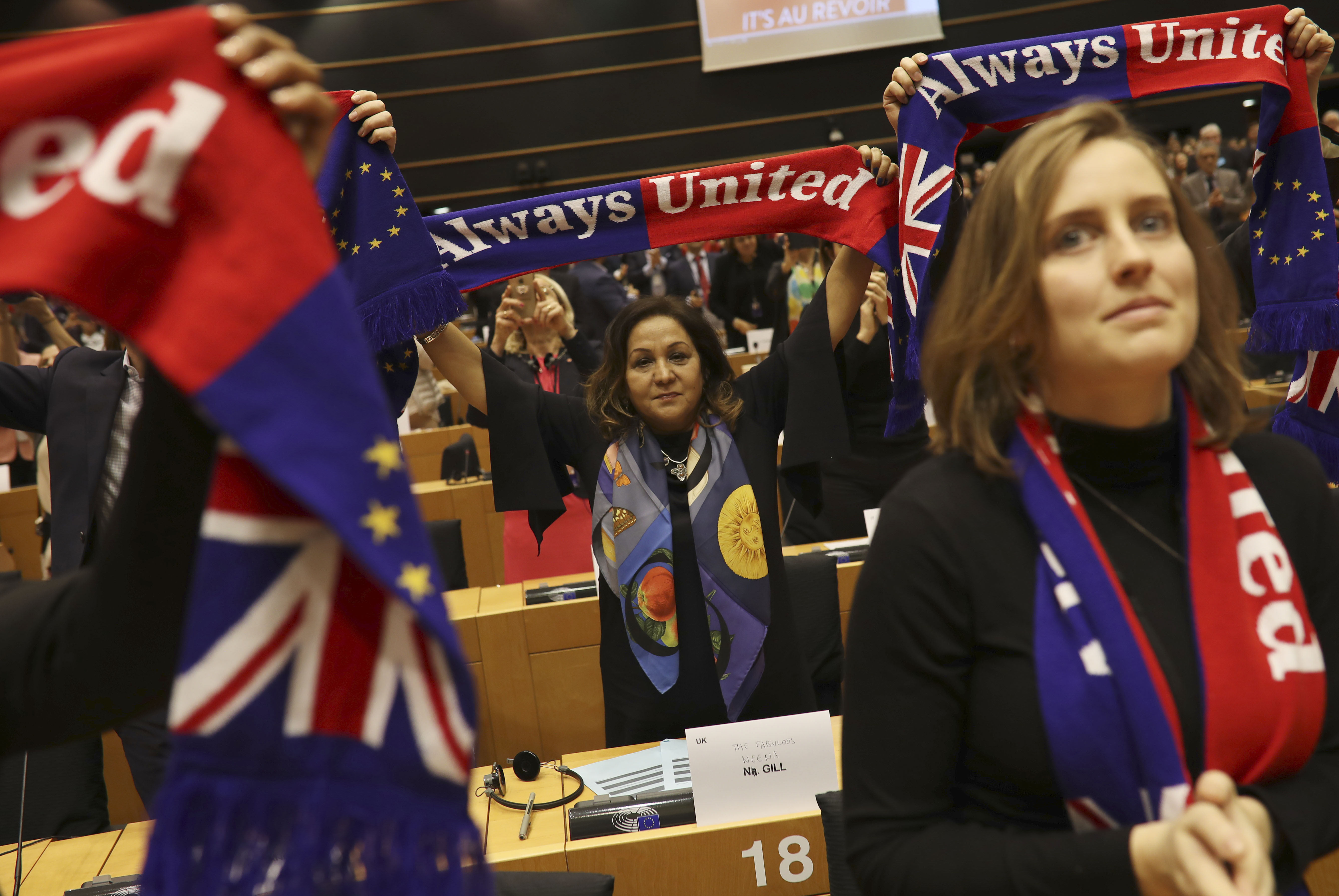 British MEP's hold up scarves during a ceremony prior to the vote on the UK's withdrawal from the EU, the final legislative step in the Brexit proceedings, at the European Parliament in Brussels